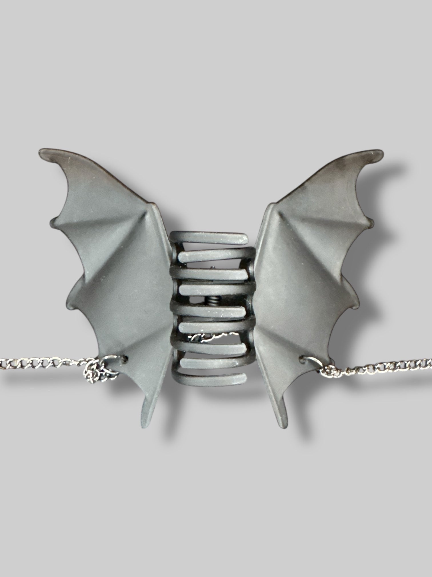 Bat wing hair clip with dangling spider chains