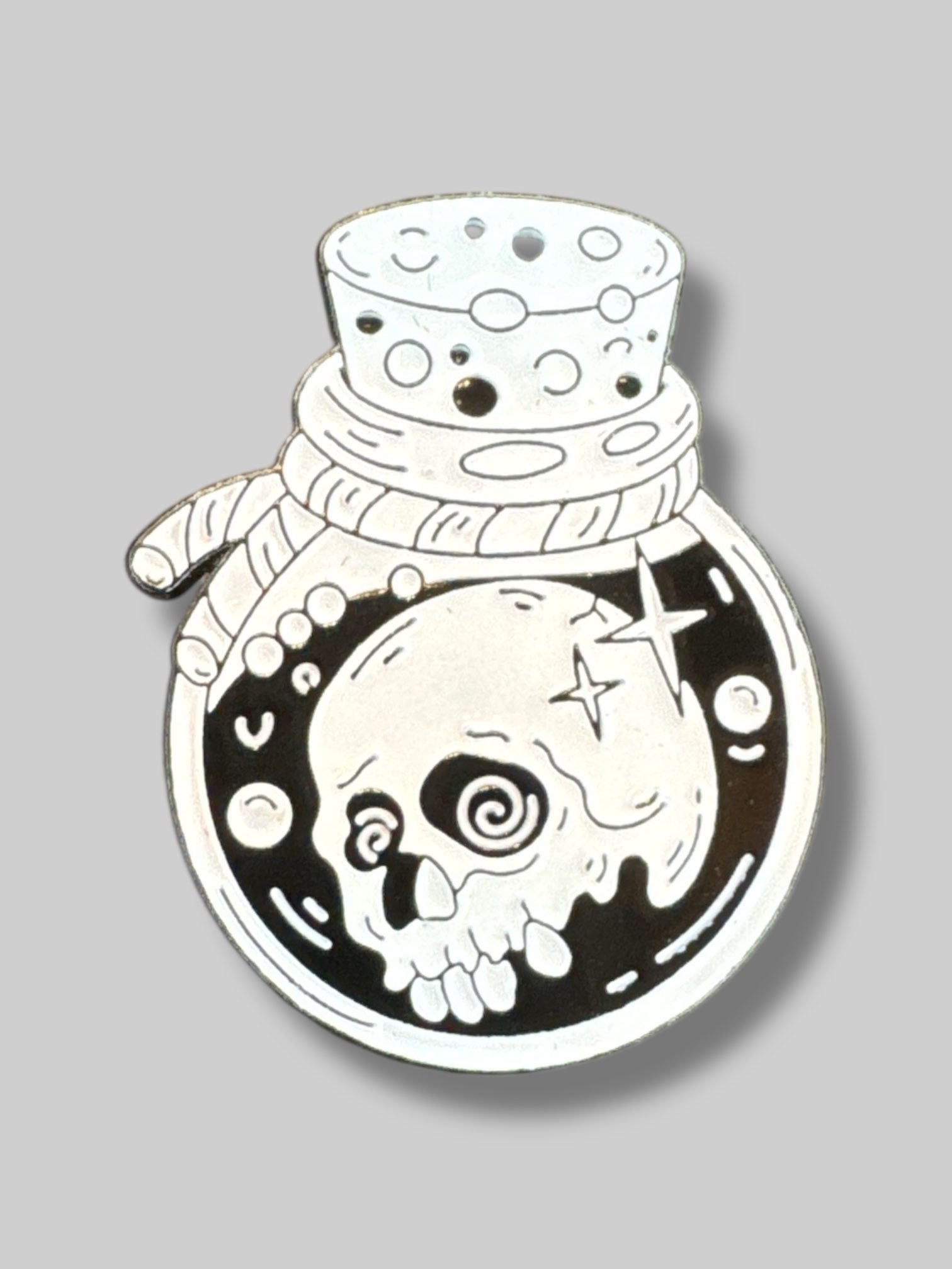 Small black and white pin with potion bottle and skull