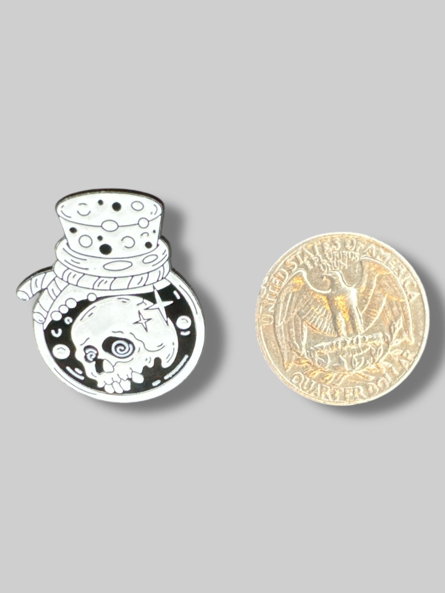 Small black and white pin with potion bottle and skull