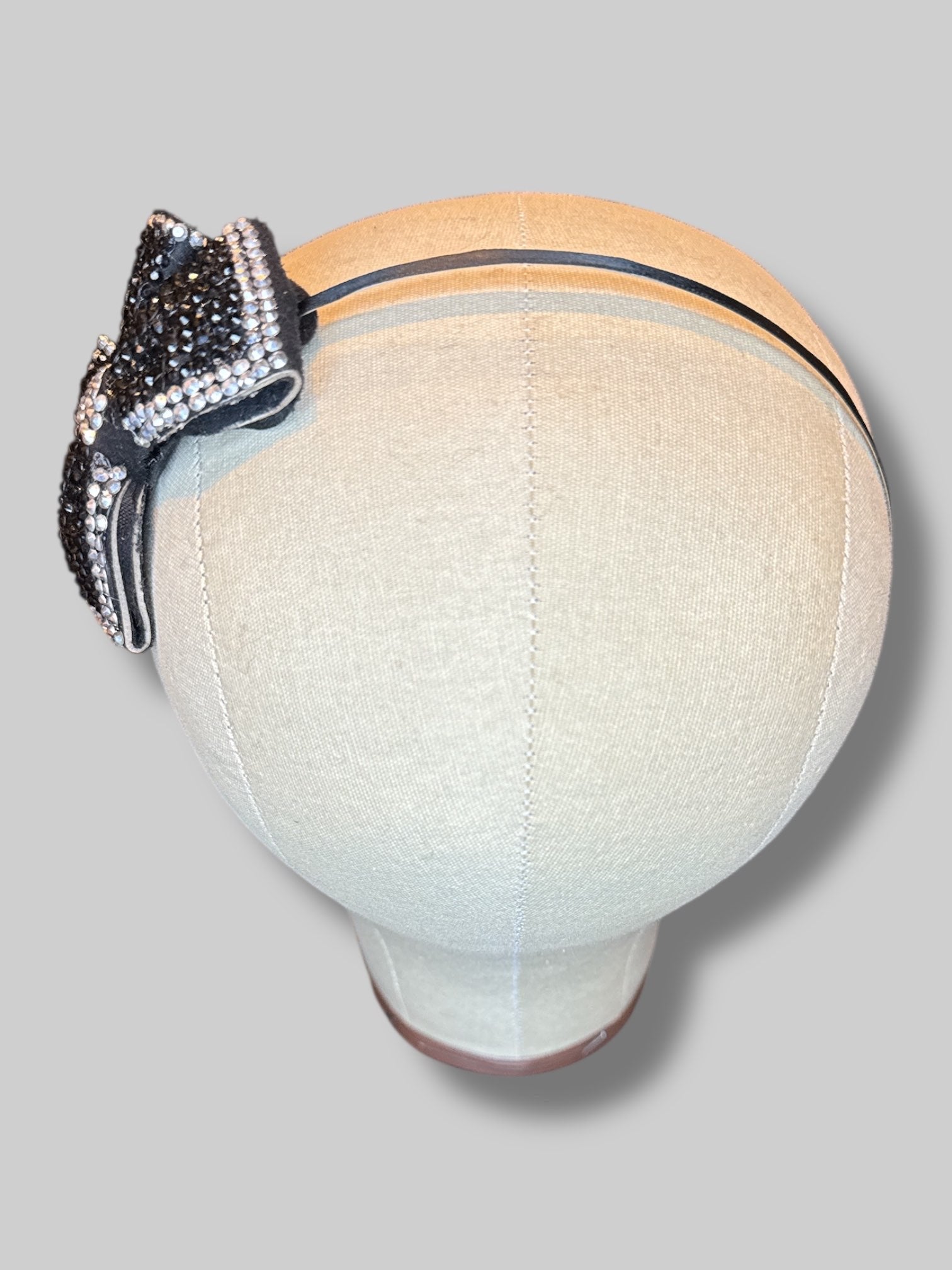 Black metal headband with black and silver bedazzled bow