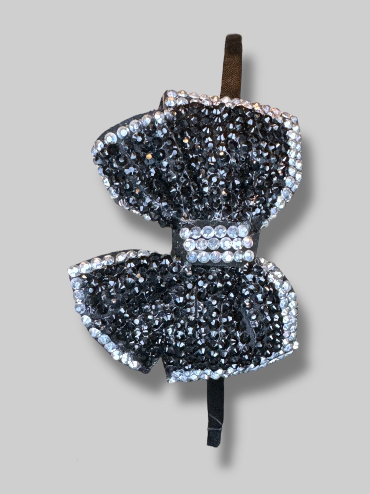 Black metal headband with black and silver bedazzled bow