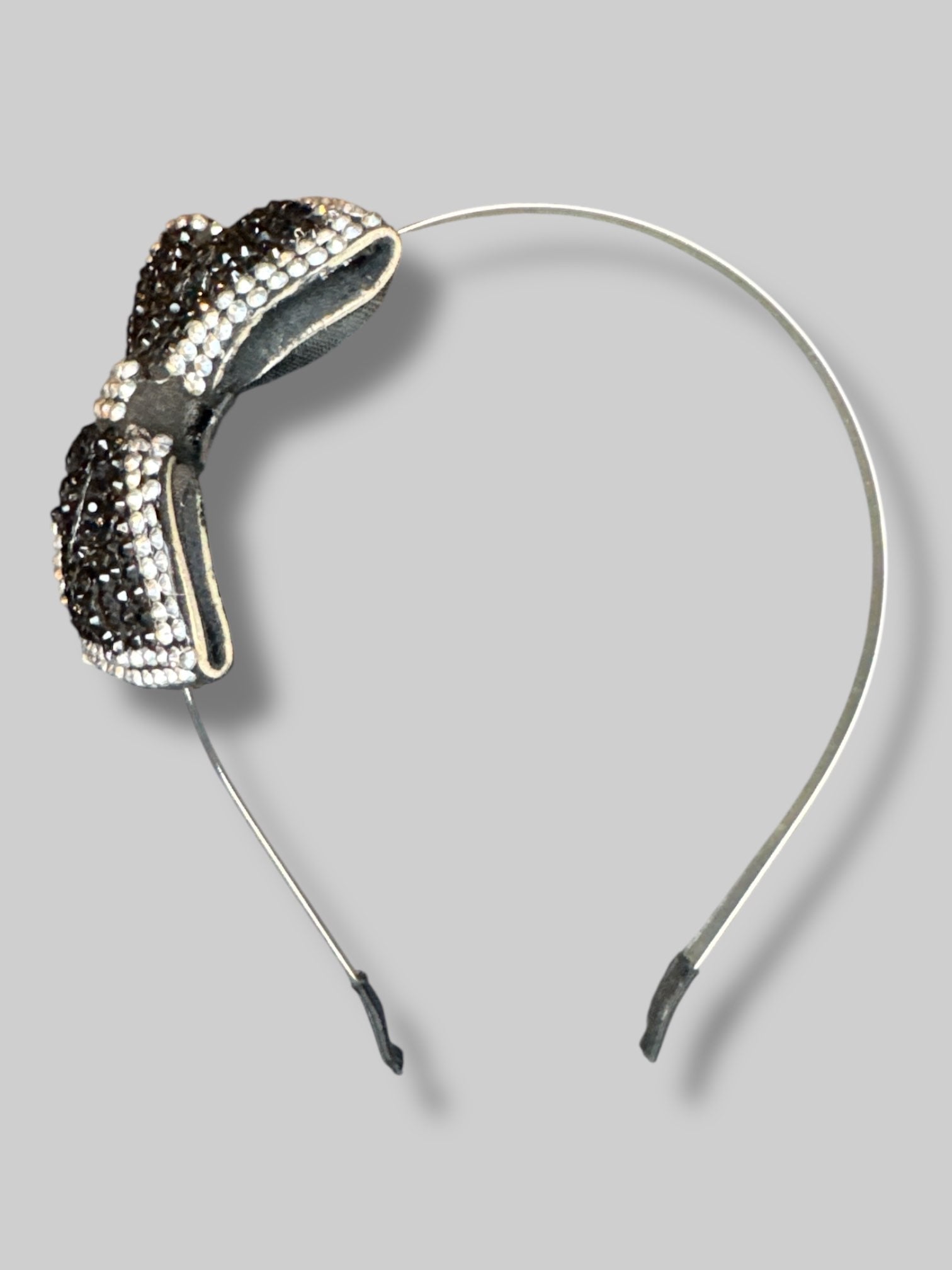Black metal headband with black and silver bedazzled bow