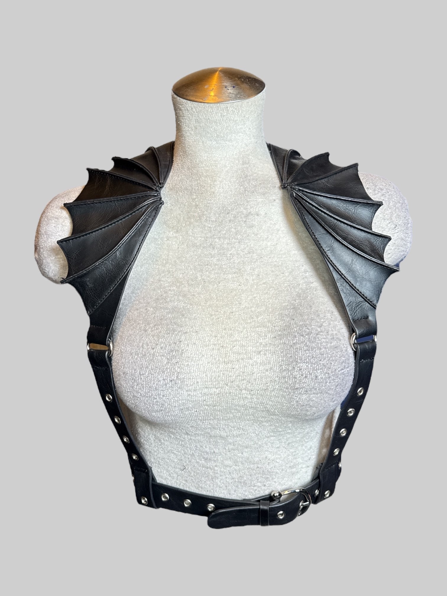 S black leather harness with batwing shaped collar, and adjustable buckle on front and back