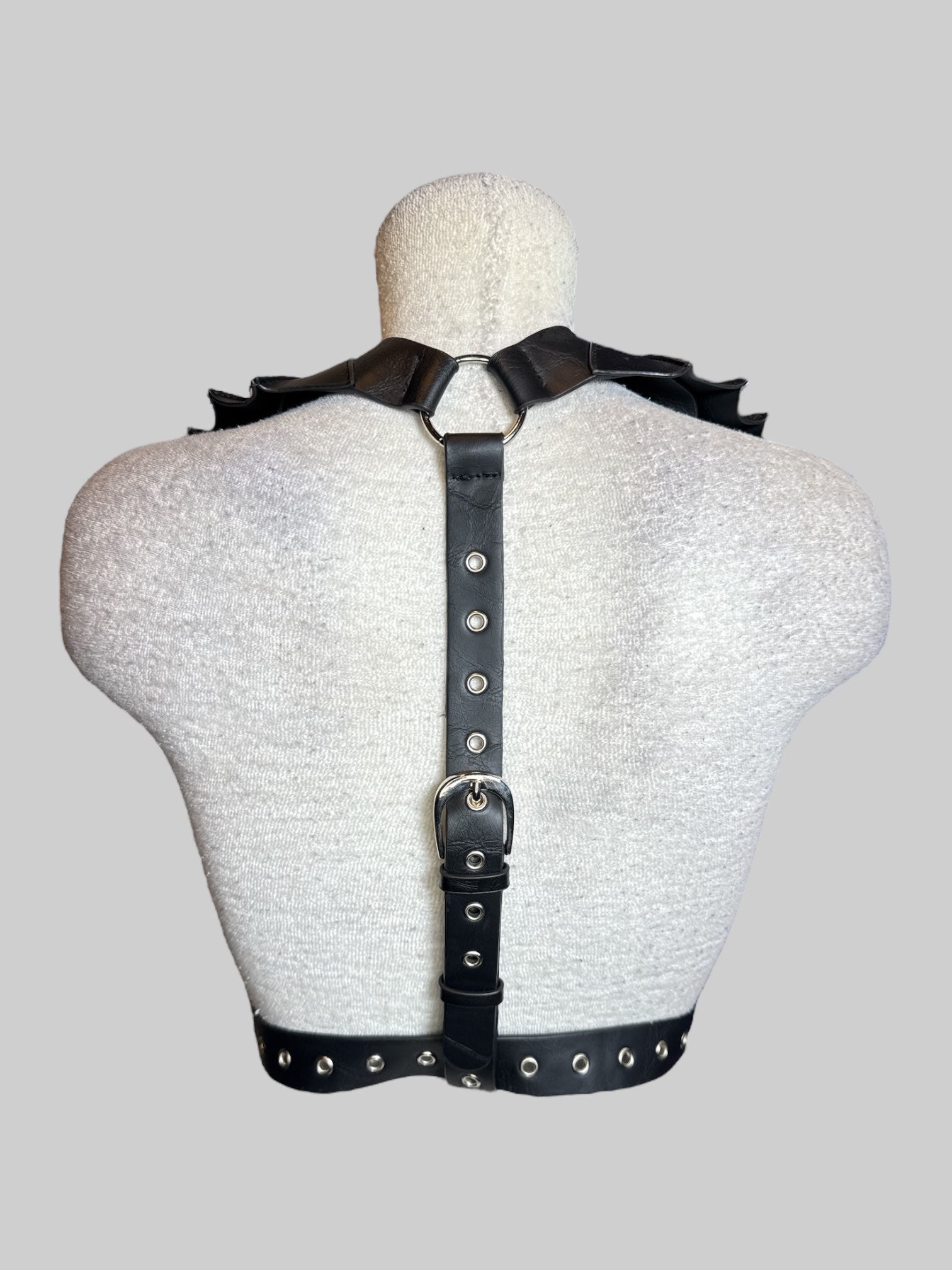 S black leather harness with batwing shaped collar, and adjustable buckle on front and back