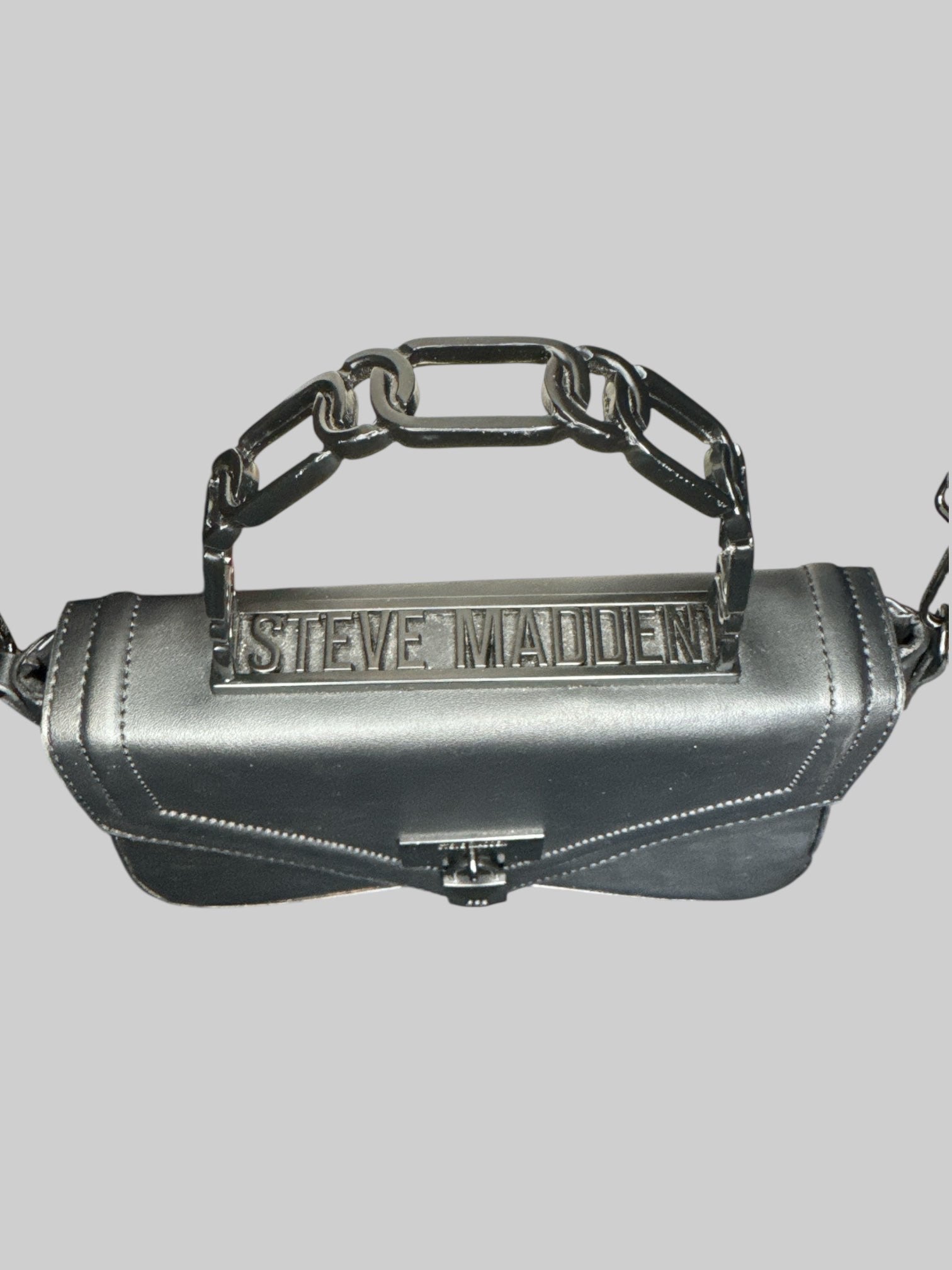 Black leather Steve Madden handbag with hard handle, shoulder strap, faux lock on front, and snap closure