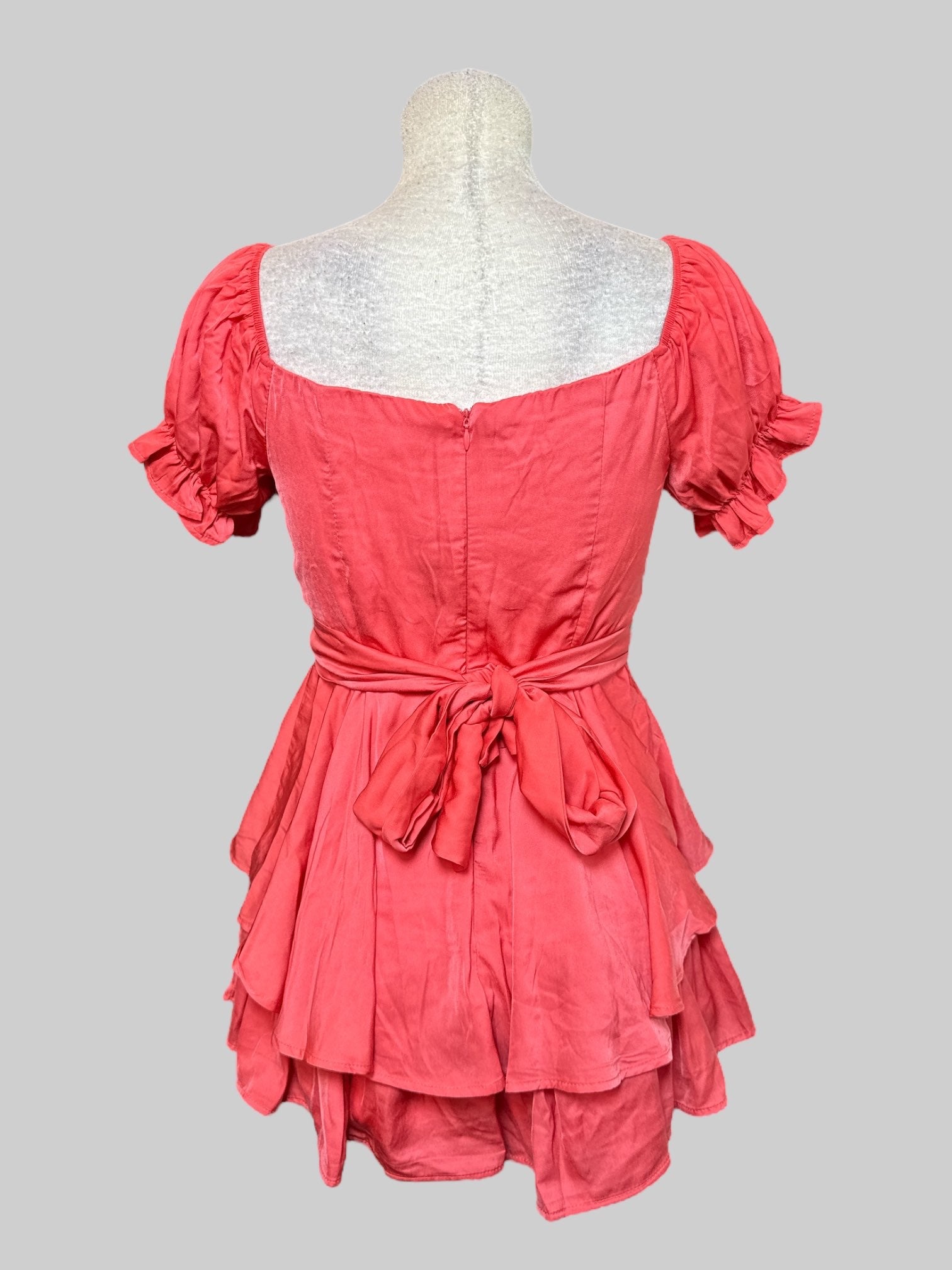M coral, short sleeve romper with elastic, squared neckline, balloon sleeves, flowy layers, and tie on back