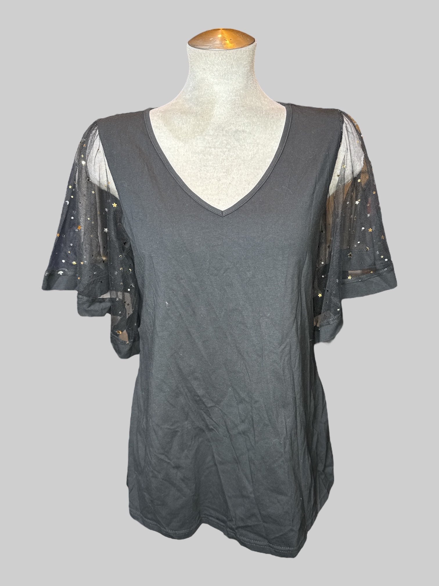 L black short sleeve top with mesh floaty, sleeves with gold stars and moons, and v-neck