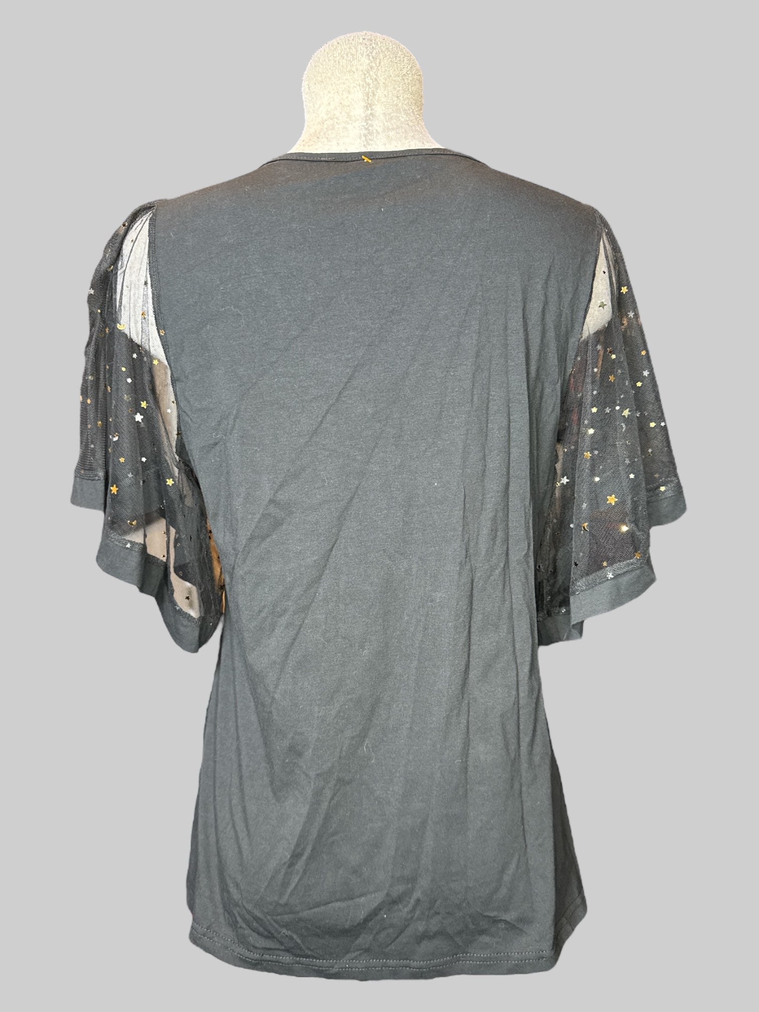 L black short sleeve top with mesh floaty, sleeves with gold stars and moons, and v-neck