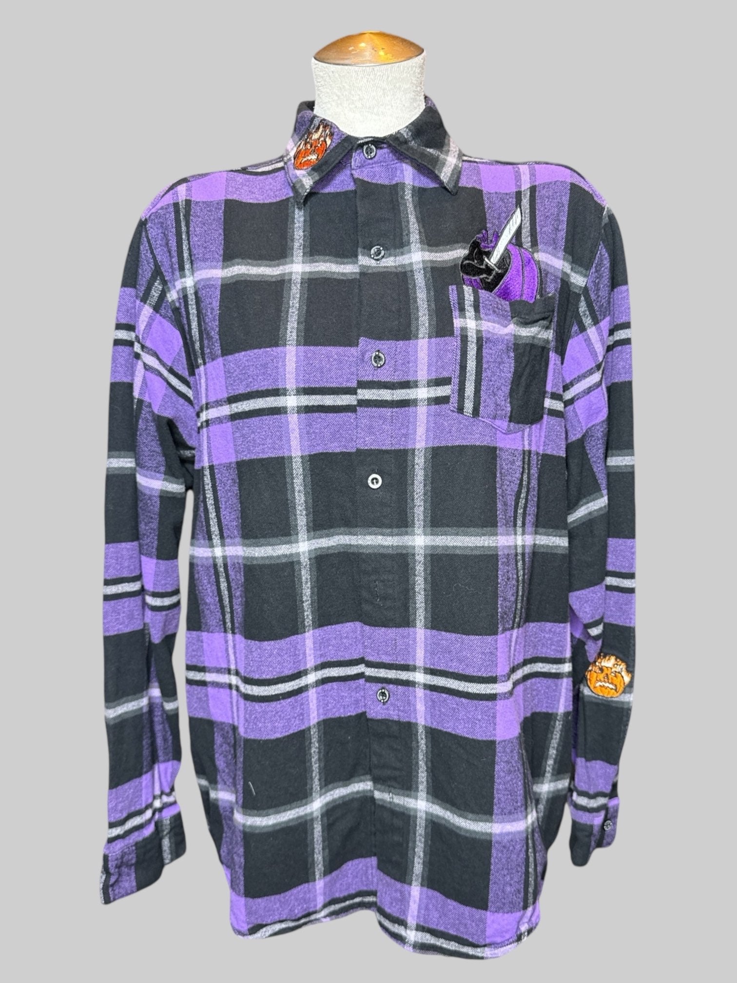 L purple and black plaid button down with Headless Horseman embroidery on front and sleeves, and “Beware the headless Horseman” graphic on back
