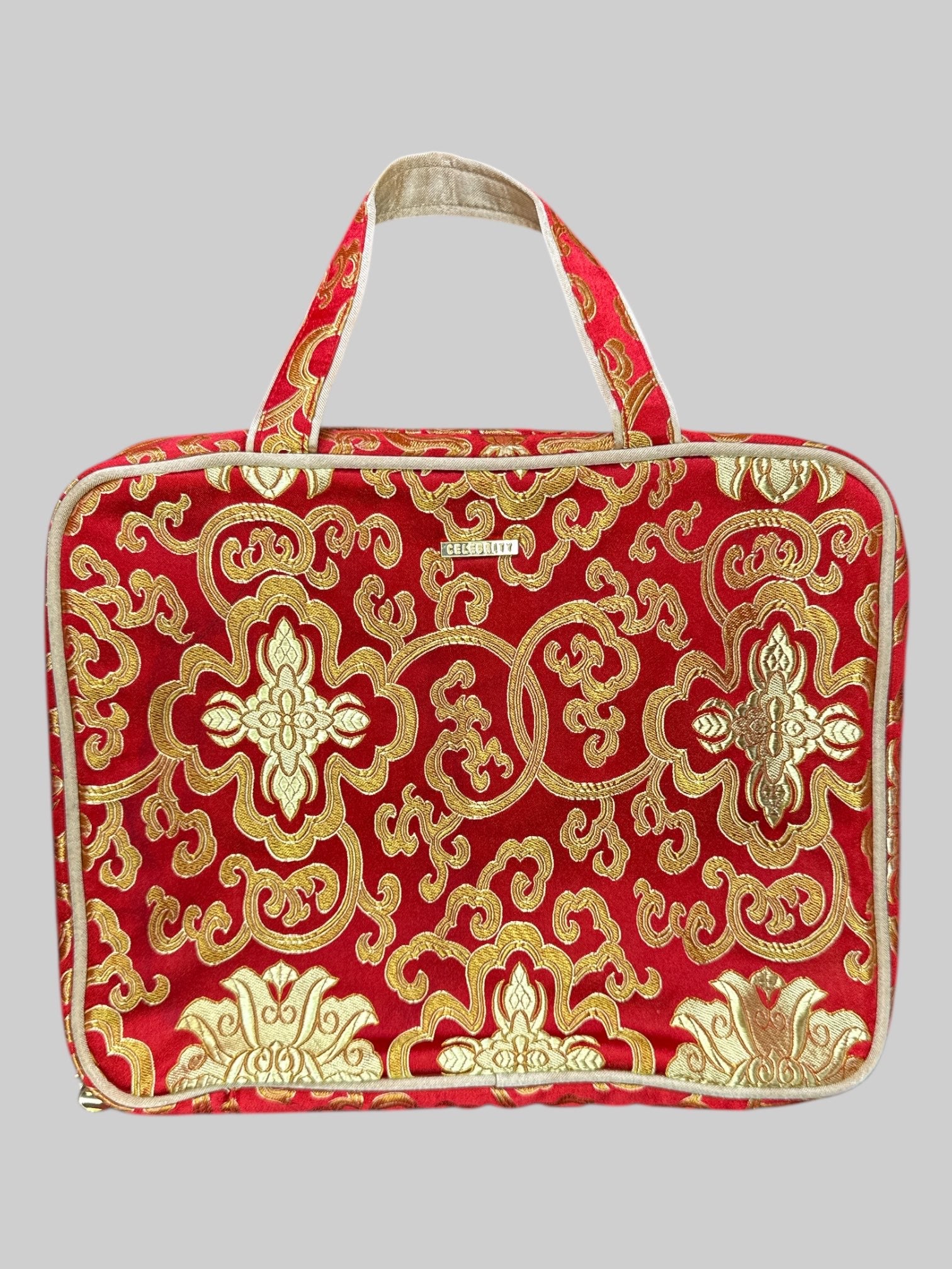 Red and gold or Nately designed handbag with multiple zipper pockets inside, and Velcro removable inside mesh pocket