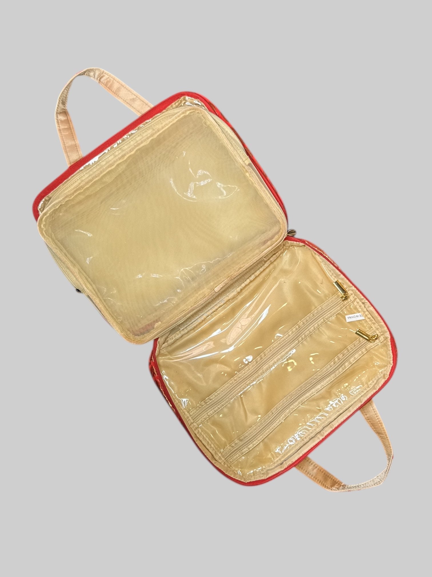 Red and gold or Nately designed handbag with multiple zipper pockets inside, and Velcro removable inside mesh pocket