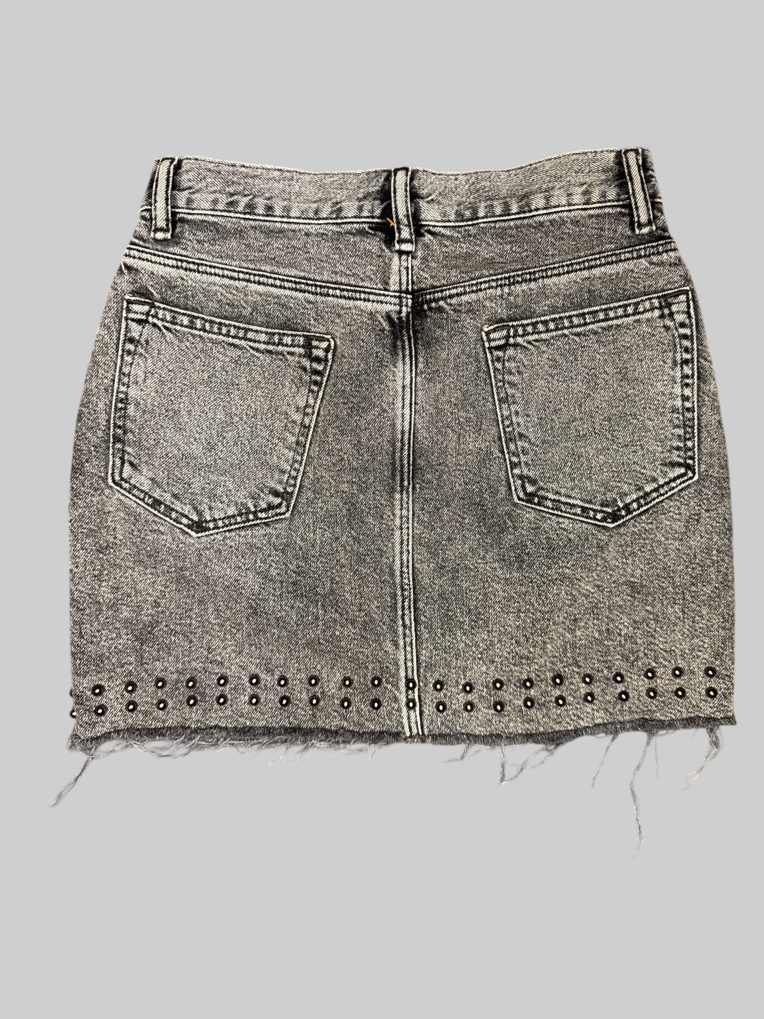 S black washed denim skirt with fringing on bottom, and small metal studs on front and back