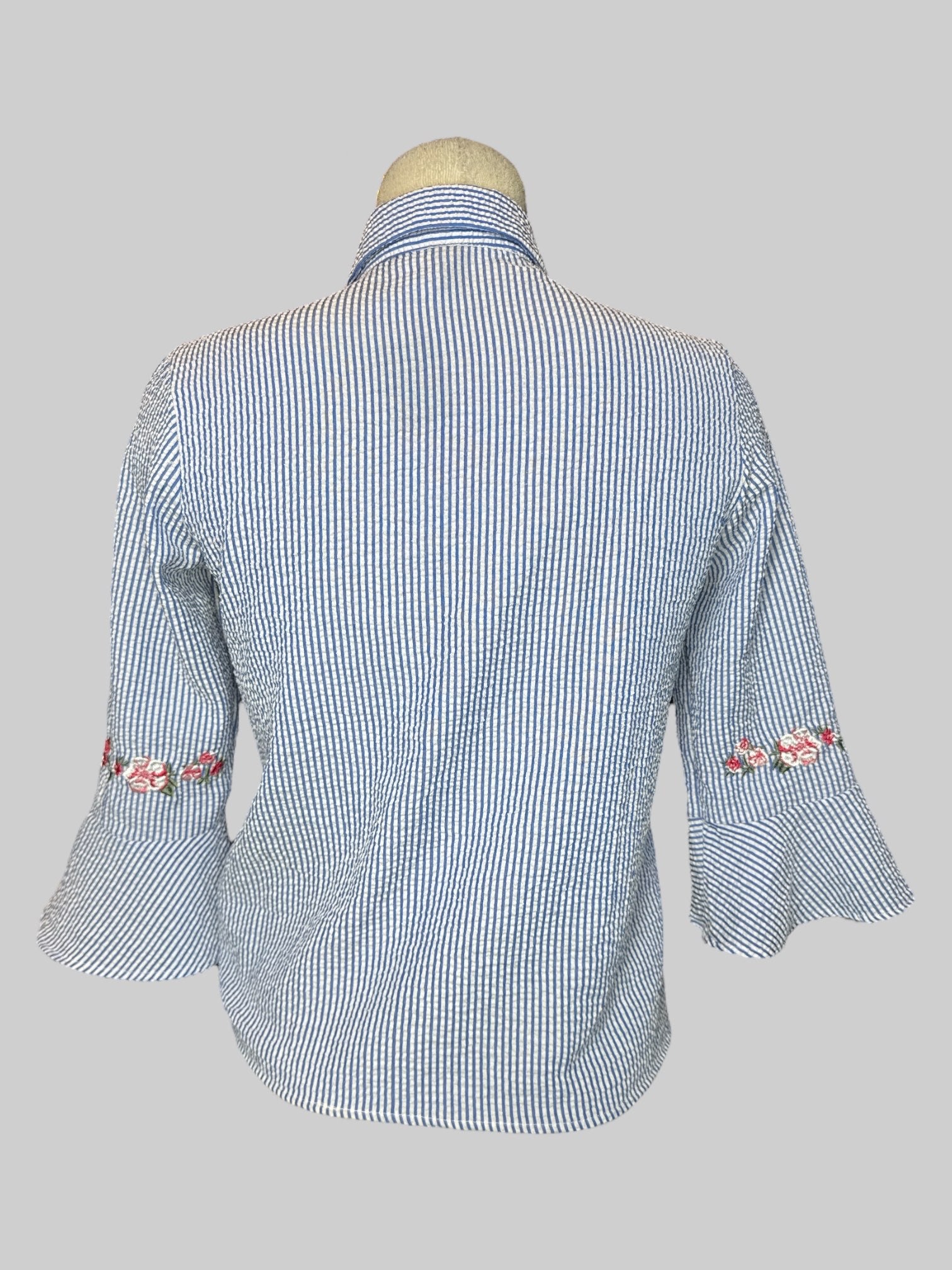 S blue and white straight button-down with flared sleeves, and pink floral embroidery on front and cuffs