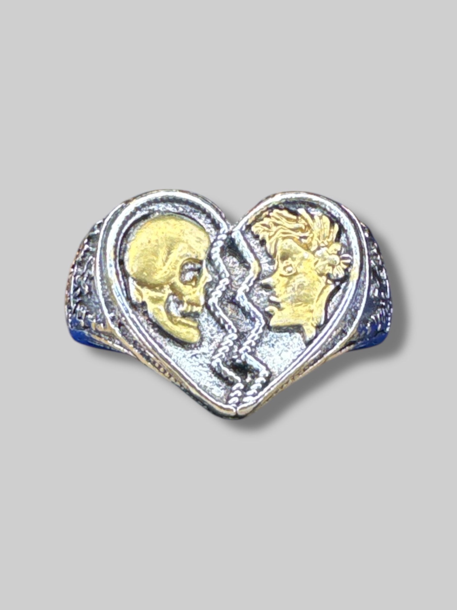 Adjustable silver tone ring with broken heart and gold color faces