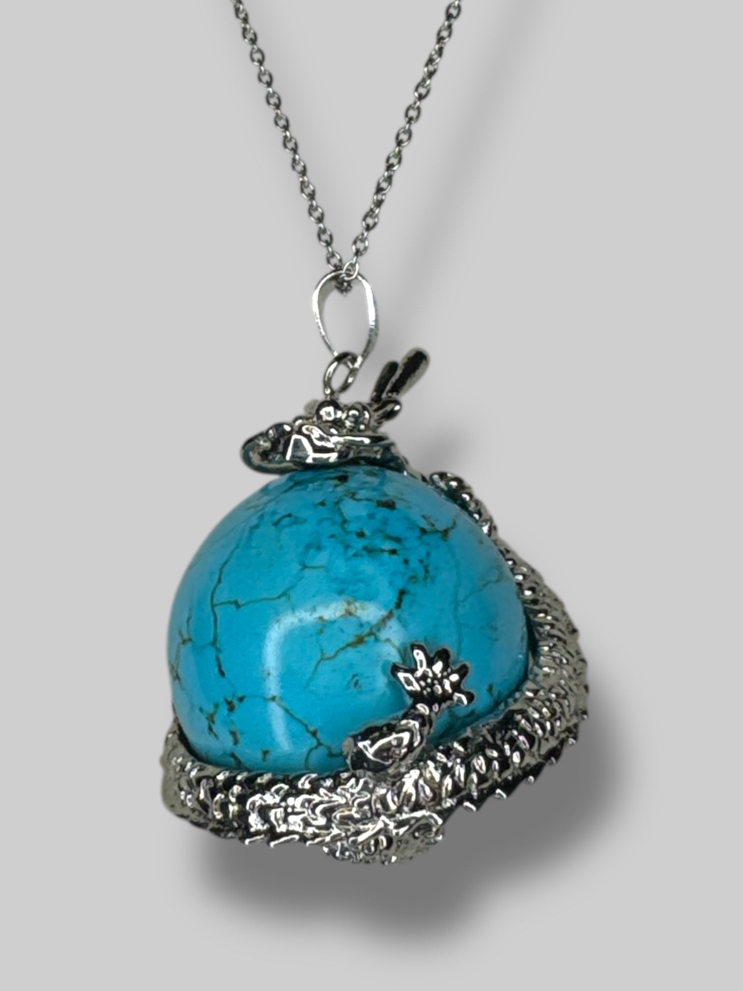 Circular  turquoise stone with silver tone dragon
