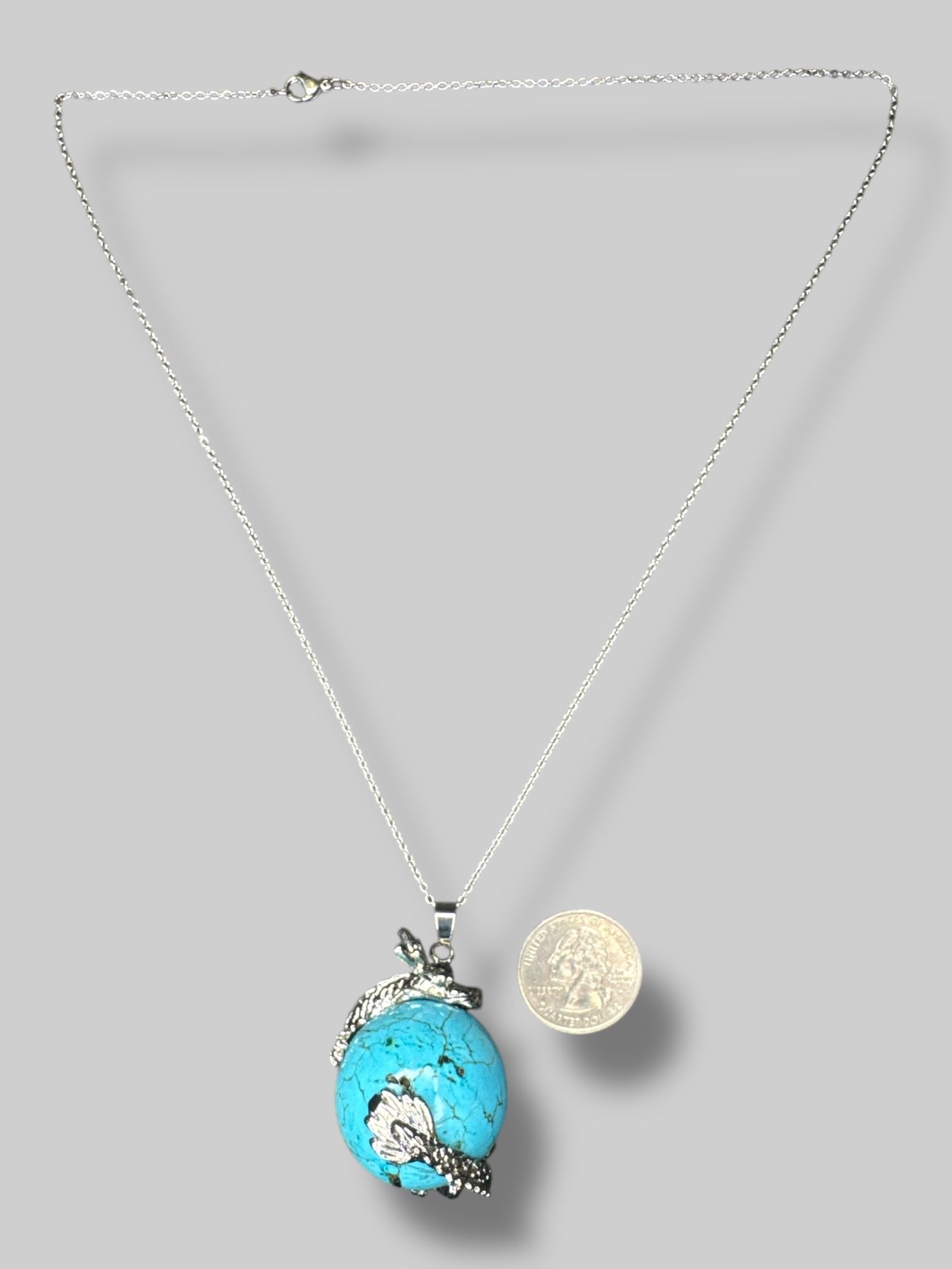 Circular  turquoise stone with silver tone dragon