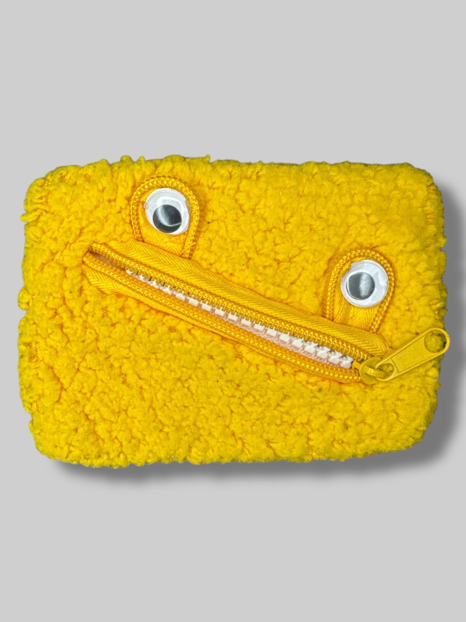 5” by 3” fuzzy yellow monster pouch