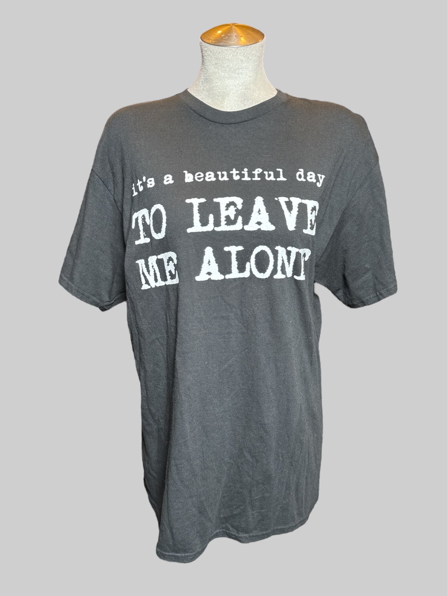 L black T-shirt  with “it’s a beautiful day to leave me alone” graphic on the front
