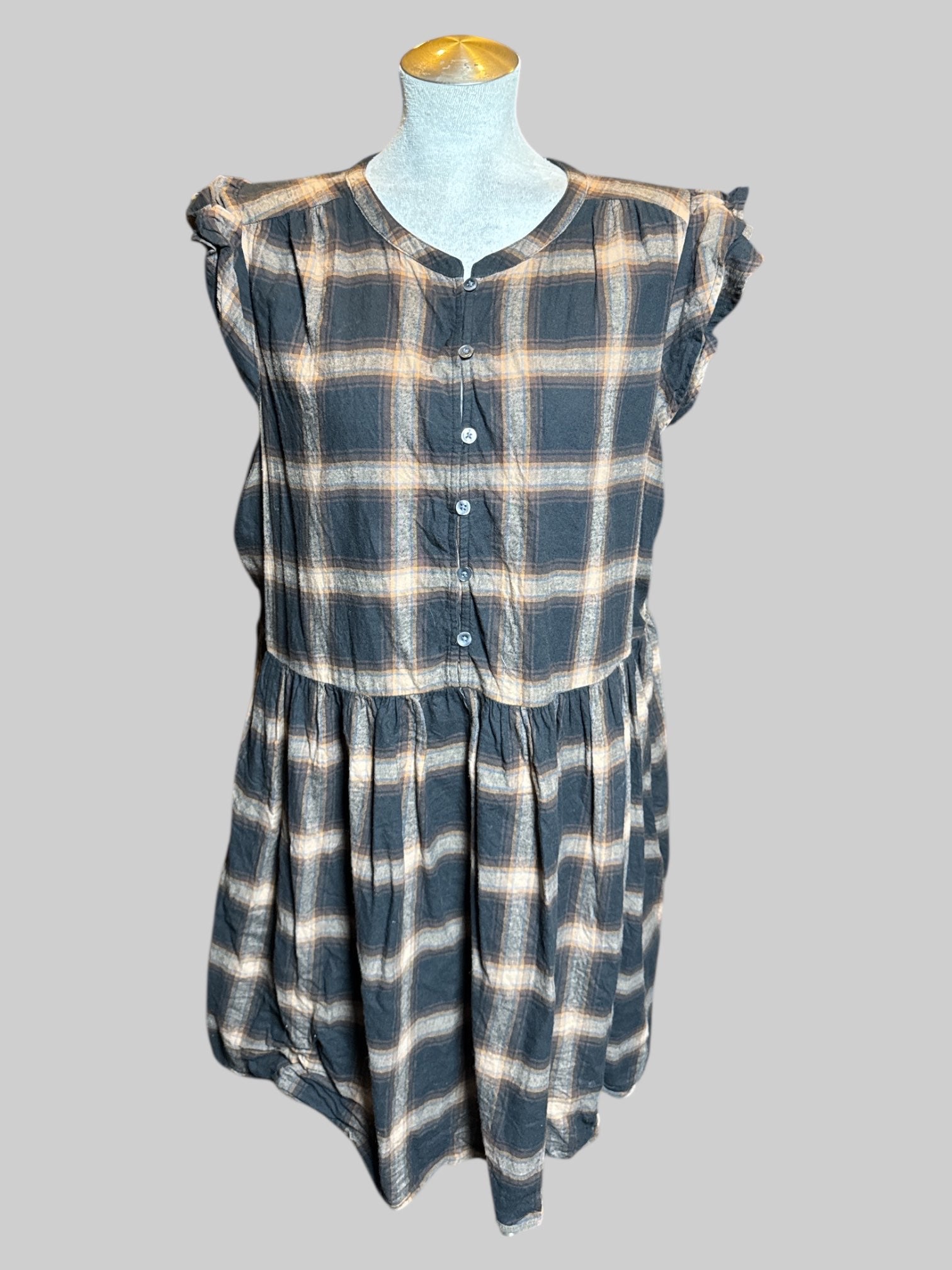 1X black and brown plaid sleeveless dress with ruffle sleeves, half buttons on front, and pockets