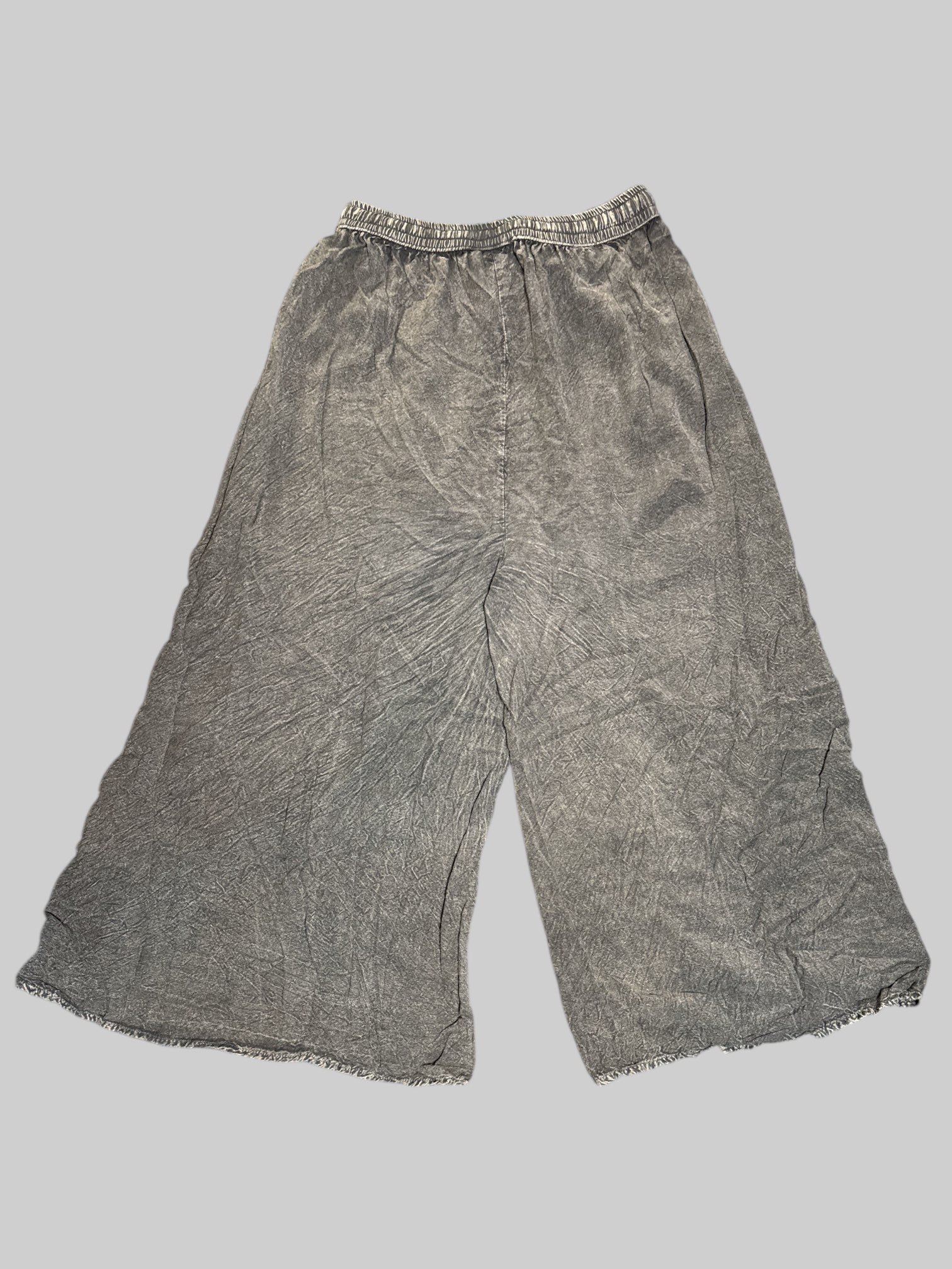 L black faded, split pants with black and white embroidery on front, drawstring, and stretchy waistband