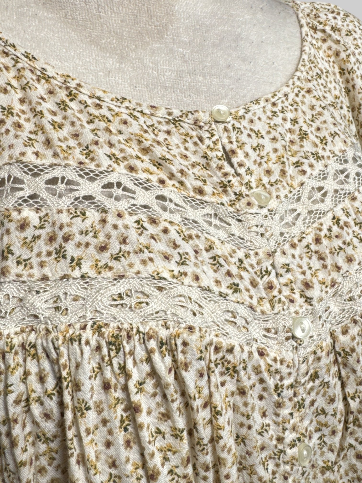 2X cream long sleeve blouse with green and brown florals, lace cut outs, and buttons