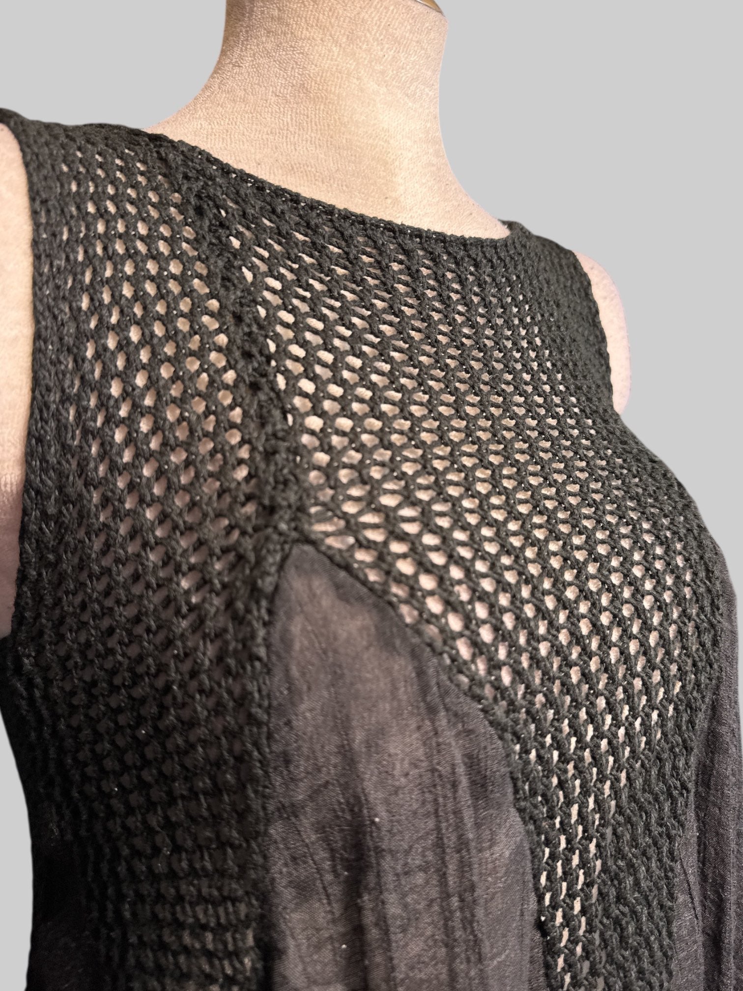 L flowy black loose knit top with sheer black panels