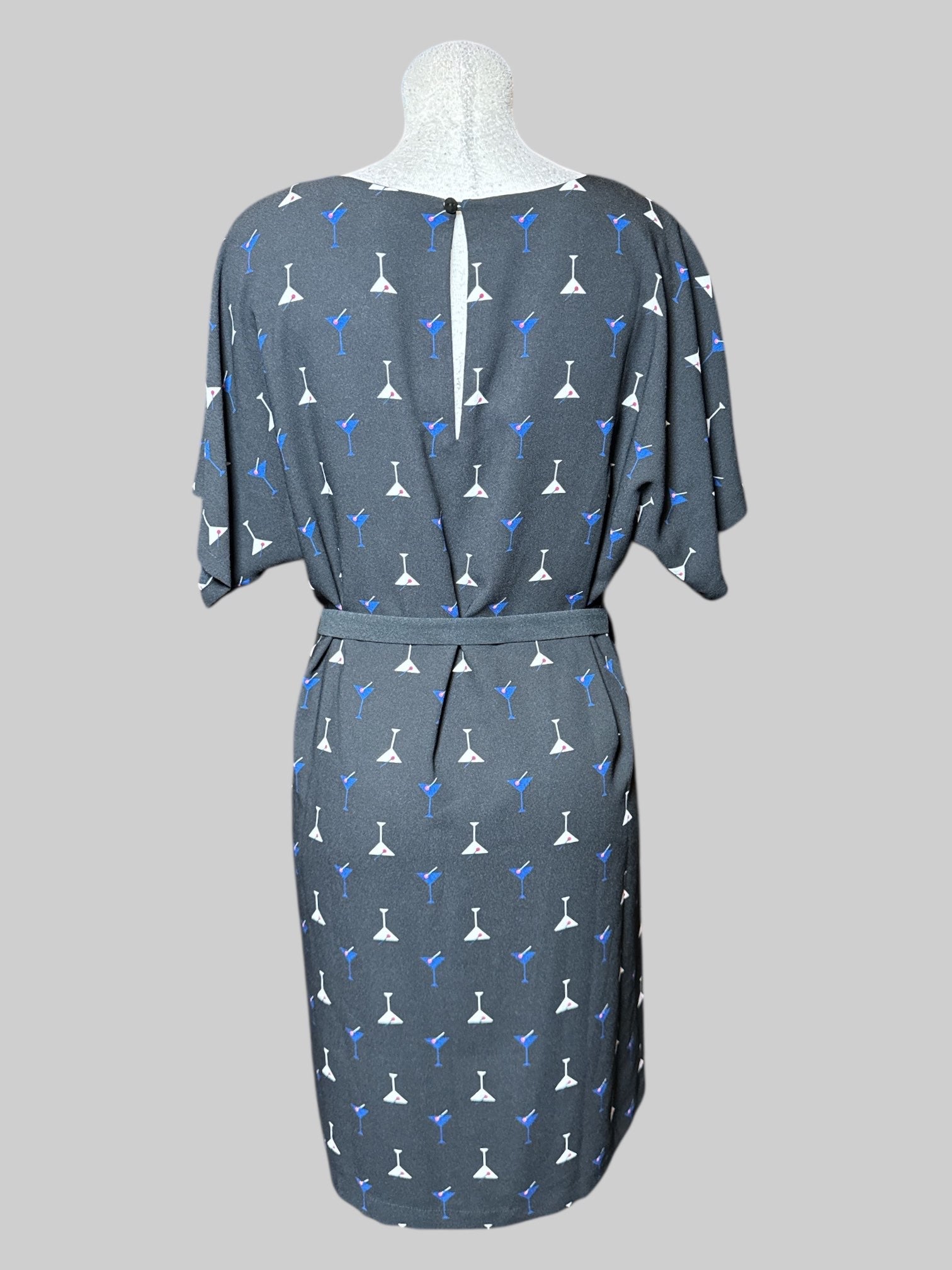 L black, short sleeve dress with multicolor, martini, print, separate belt, and keyhole and button on back