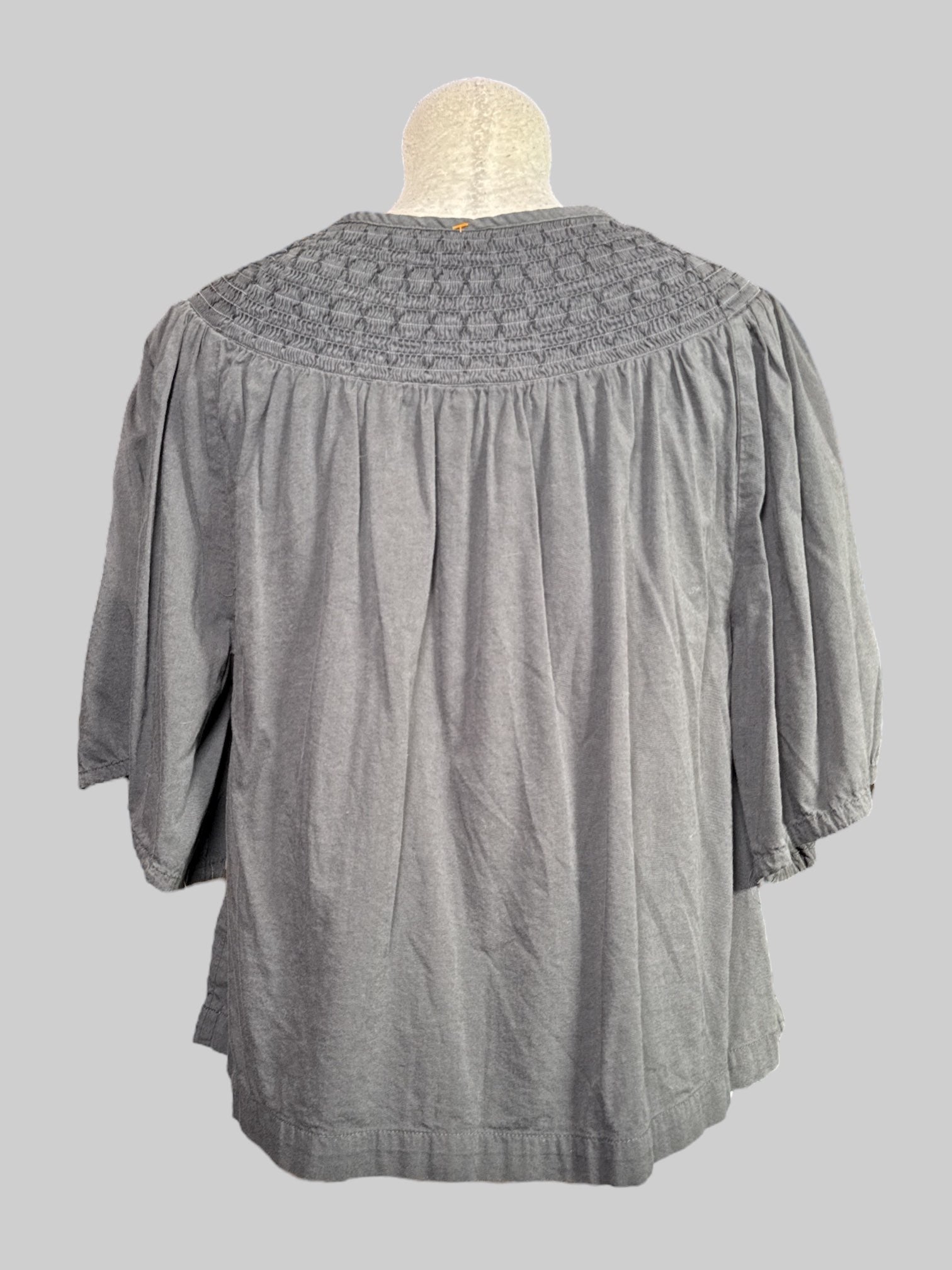 L gray short sleeve floaty top with shirred collar and tie with tassels on neck line