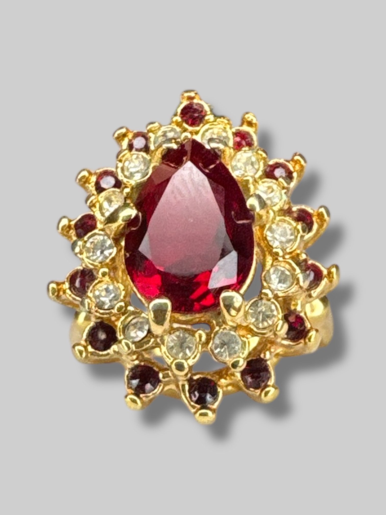 Size 6 gold tone ring with red and white gem stones