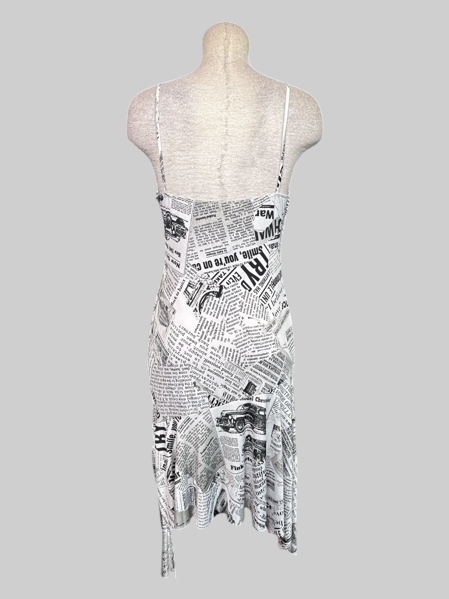 1X NWT white sleeveless dress with newspaper print, asymmetrical, hem, droopy, neckline, and metal figure eights on straps