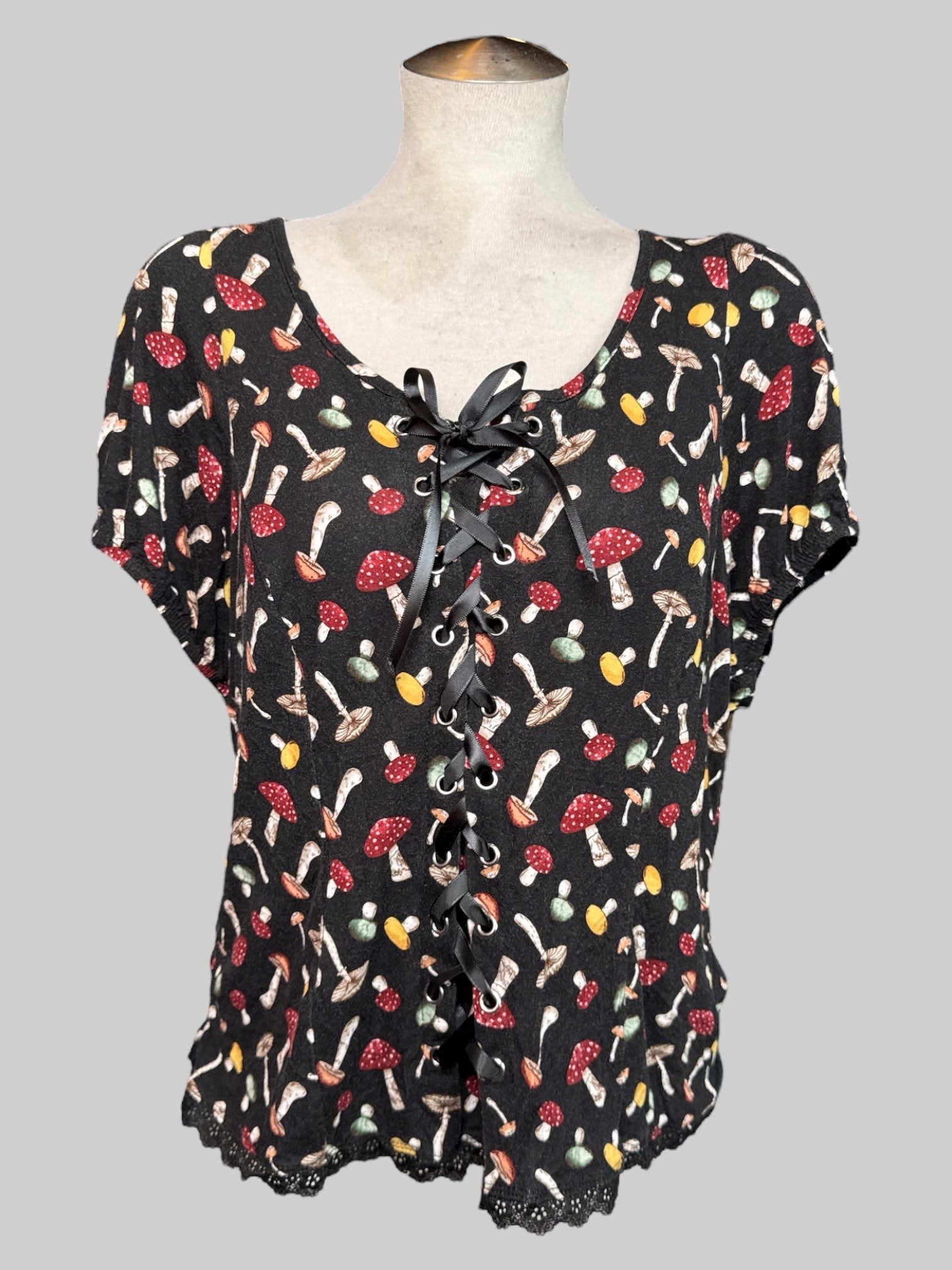 2X black short sleeve top with mushroom print, lacing on front, and balloon sleeves