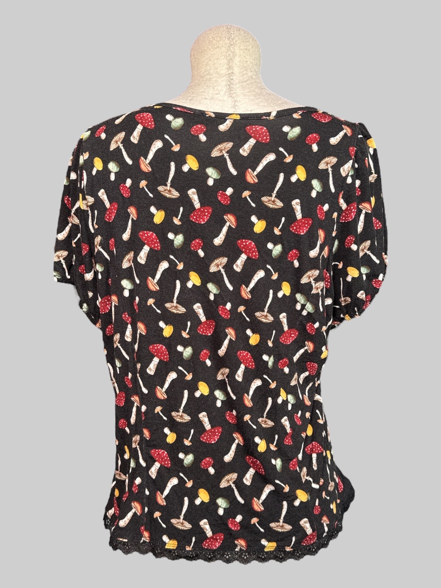2X black short sleeve top with mushroom print, lacing on front, and balloon sleeves