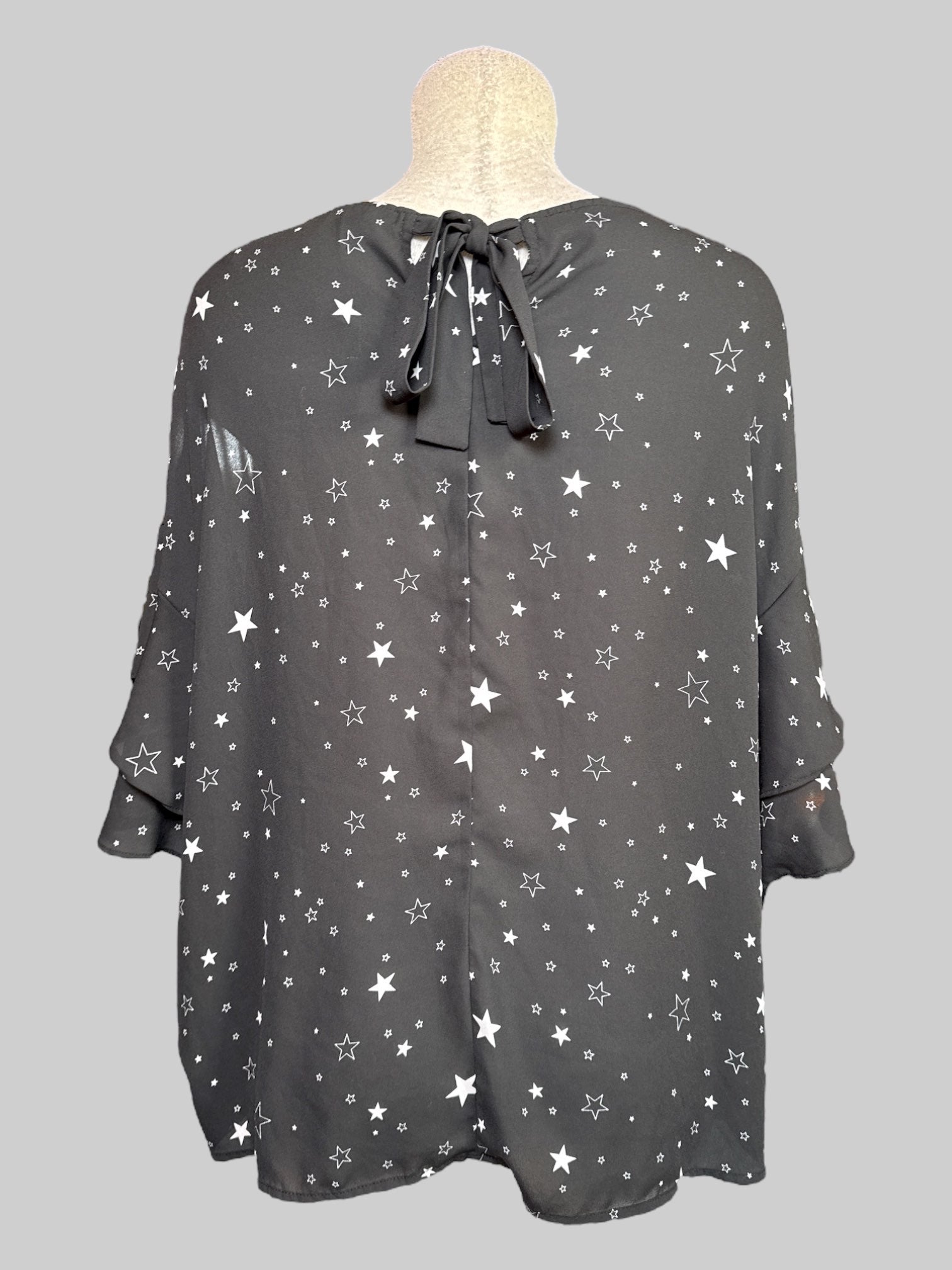 2X black half sleeve top with stars, print, ruffle, layered sleeves, and tie on back neck