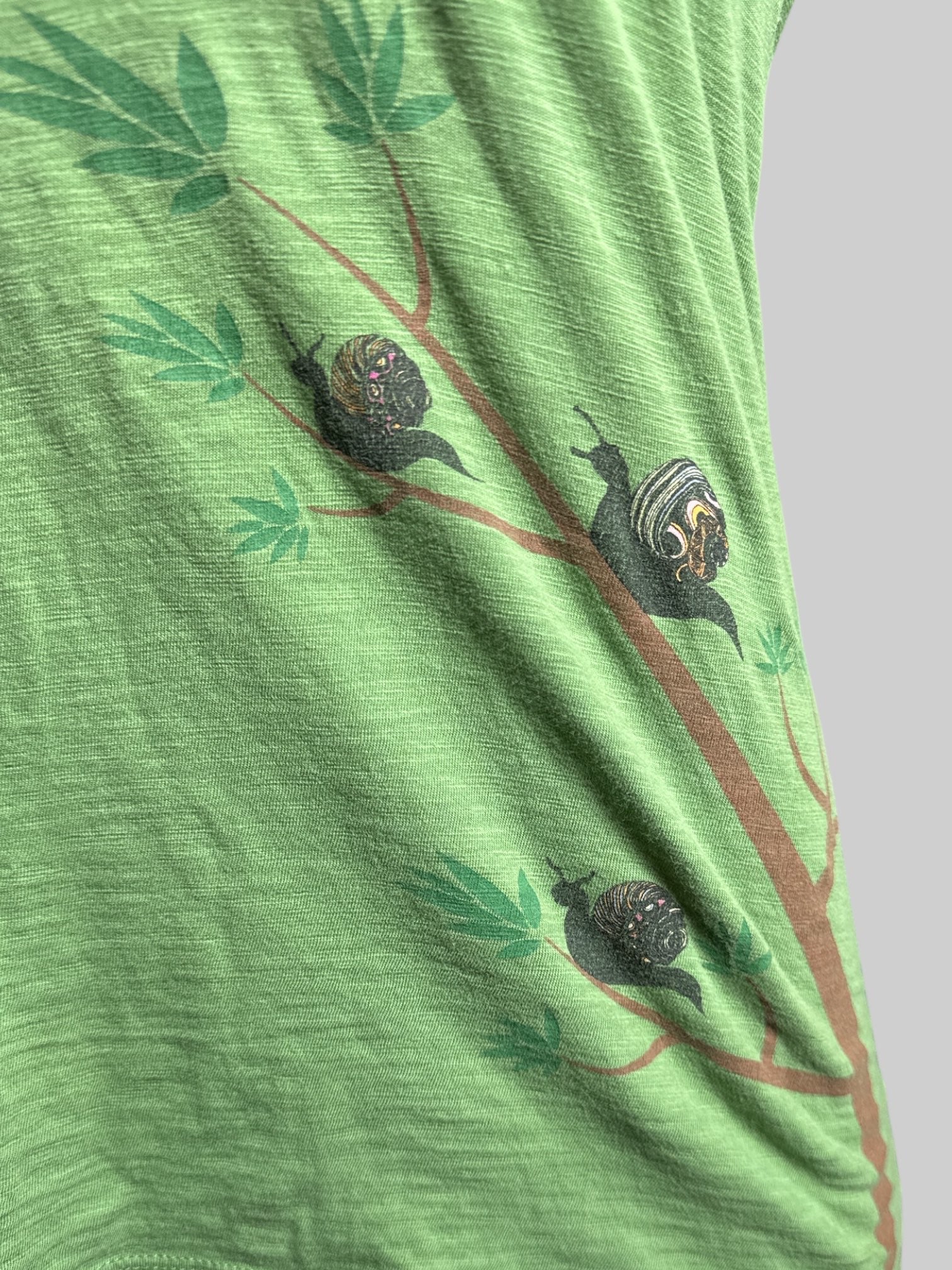 M green v neck t shirt with snails graphic