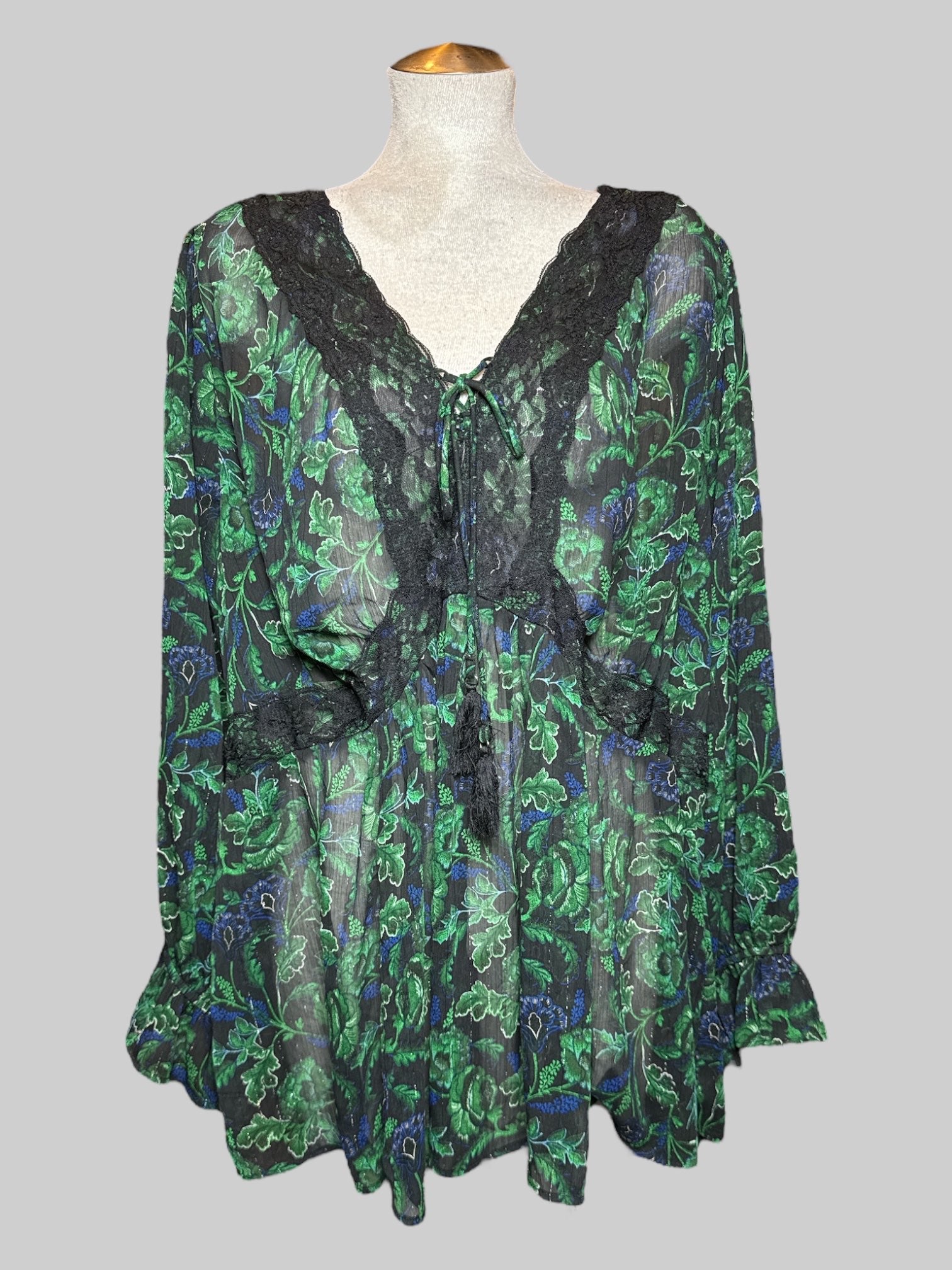 3X sheer black long sleeve blouse with metallic silver, green and blue florals, drawstring, and lace details