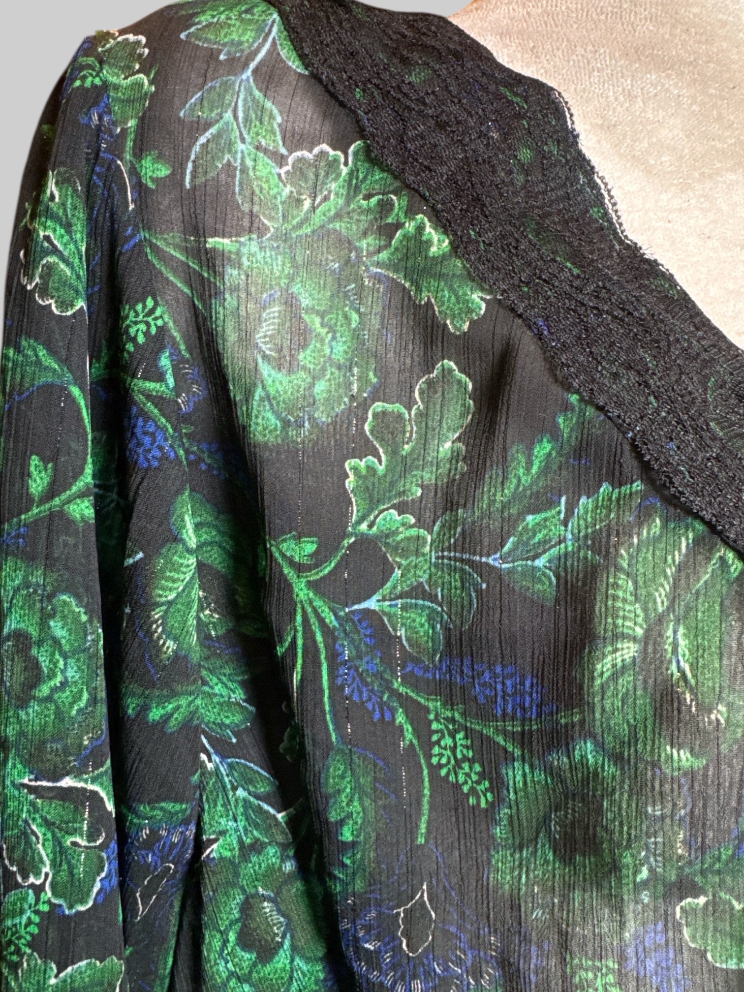 3X sheer black long sleeve blouse with metallic silver, green and blue florals, drawstring, and lace details