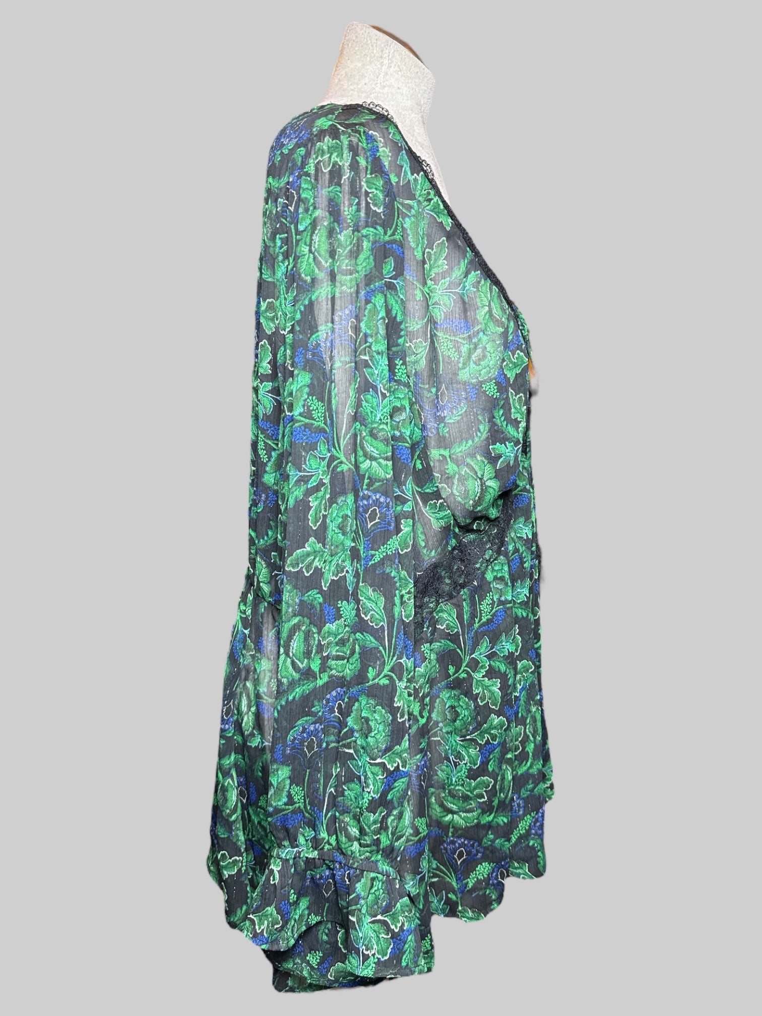 3X sheer black long sleeve blouse with metallic silver, green and blue florals, drawstring, and lace details