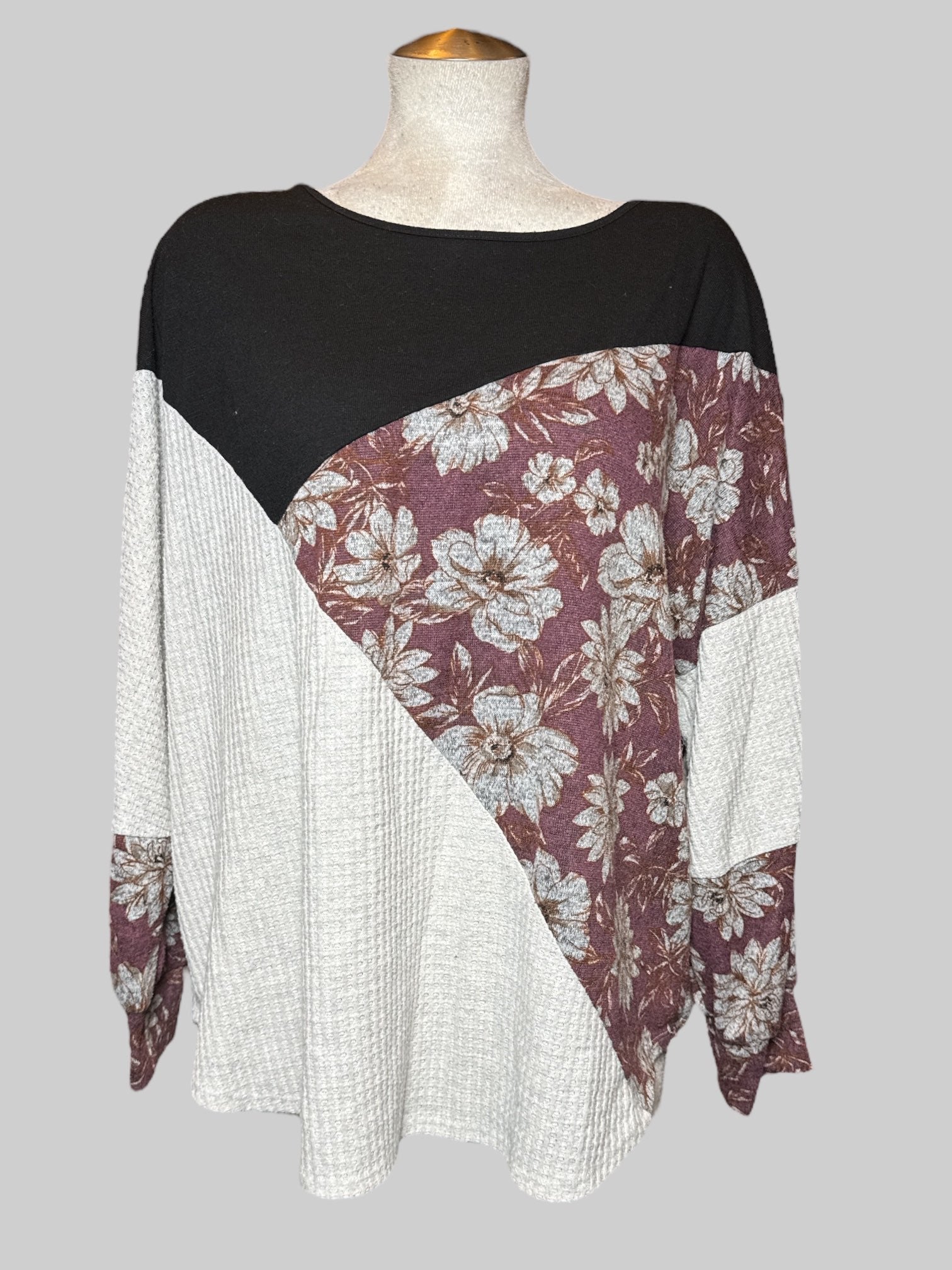 3X long sleeve top with part off white waffle knit, purple and white florals, and black