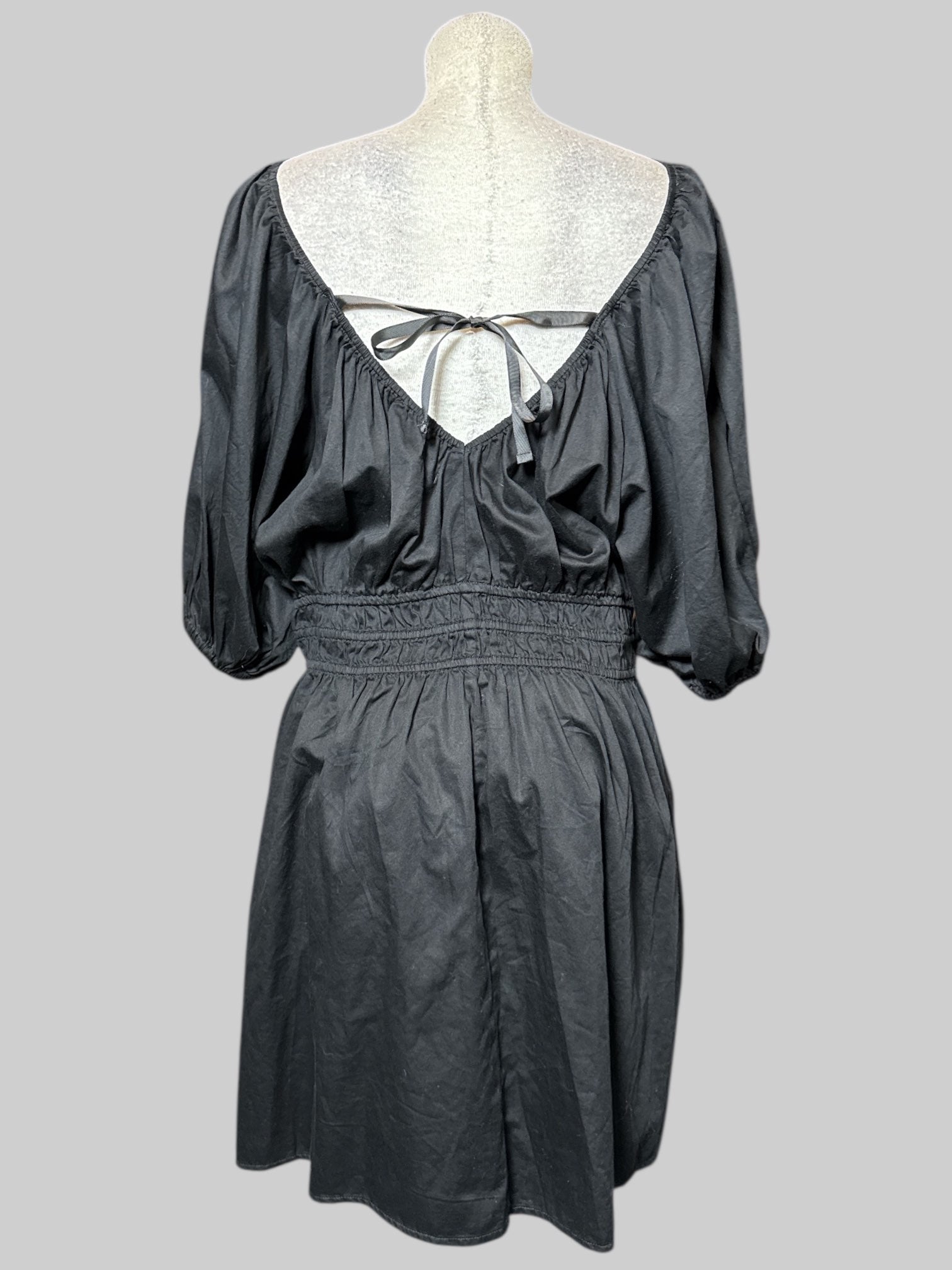 3X black, short sleeve dress with balloon sleeves, multiple elastic bands on waist and neck line, pockets, and tie on back