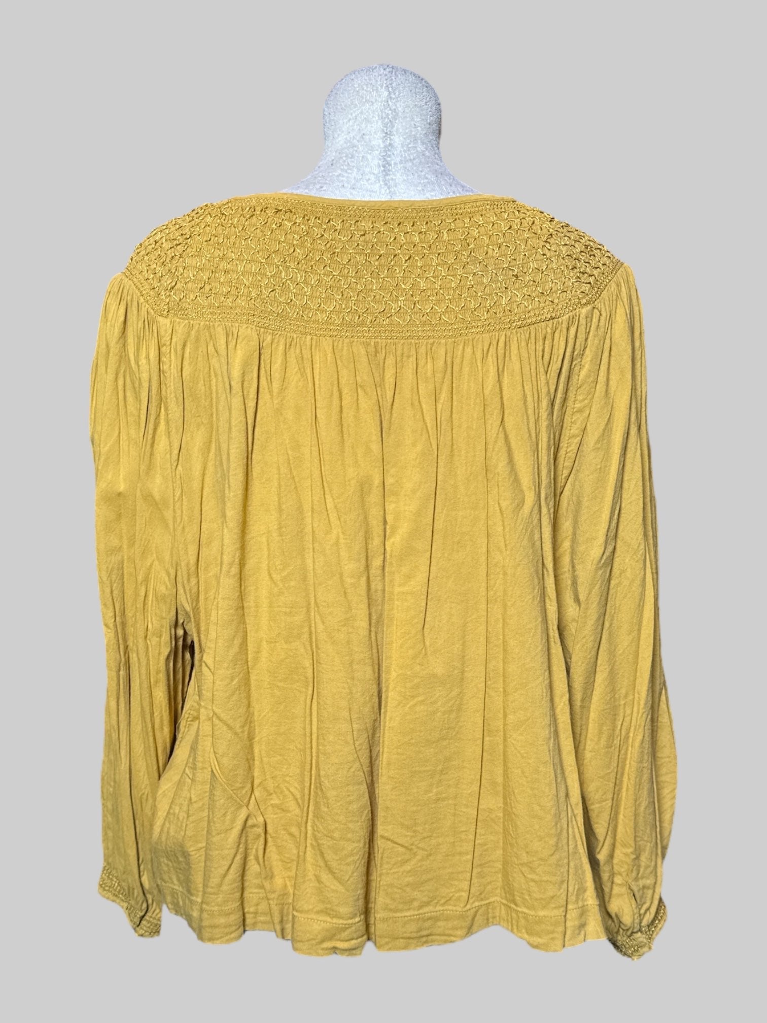 4X yellow long sleeve top with shirring and embroidery on neckline, tie on front,  and buttons on cuffs