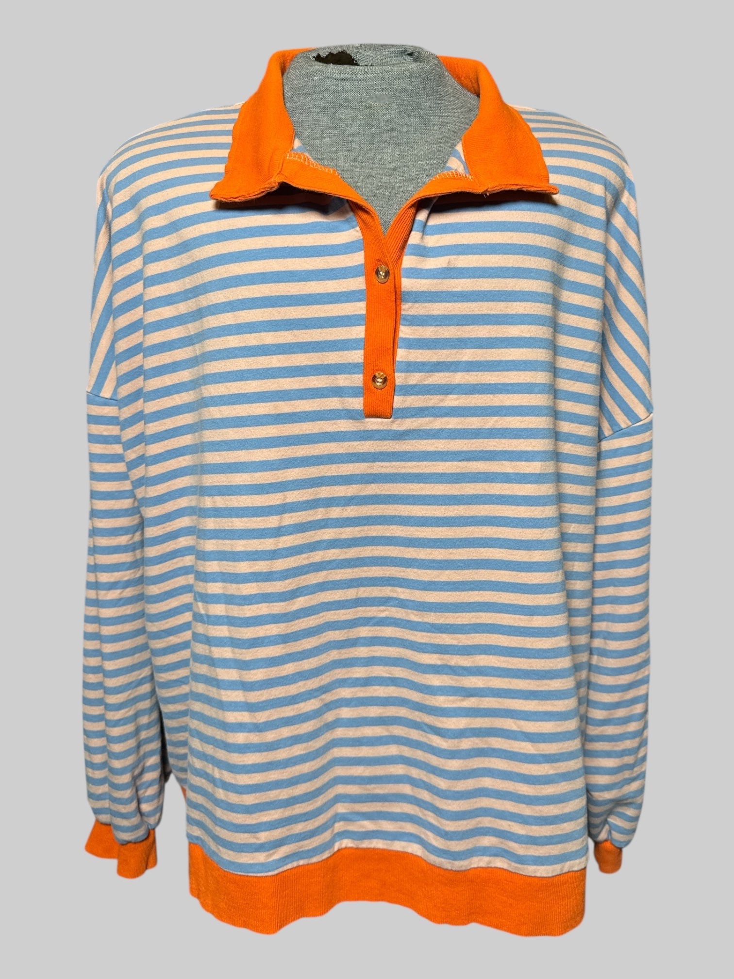 7X light, orange and blue striped long sleeve top with collar and two buttons, and orange hems and cuffs