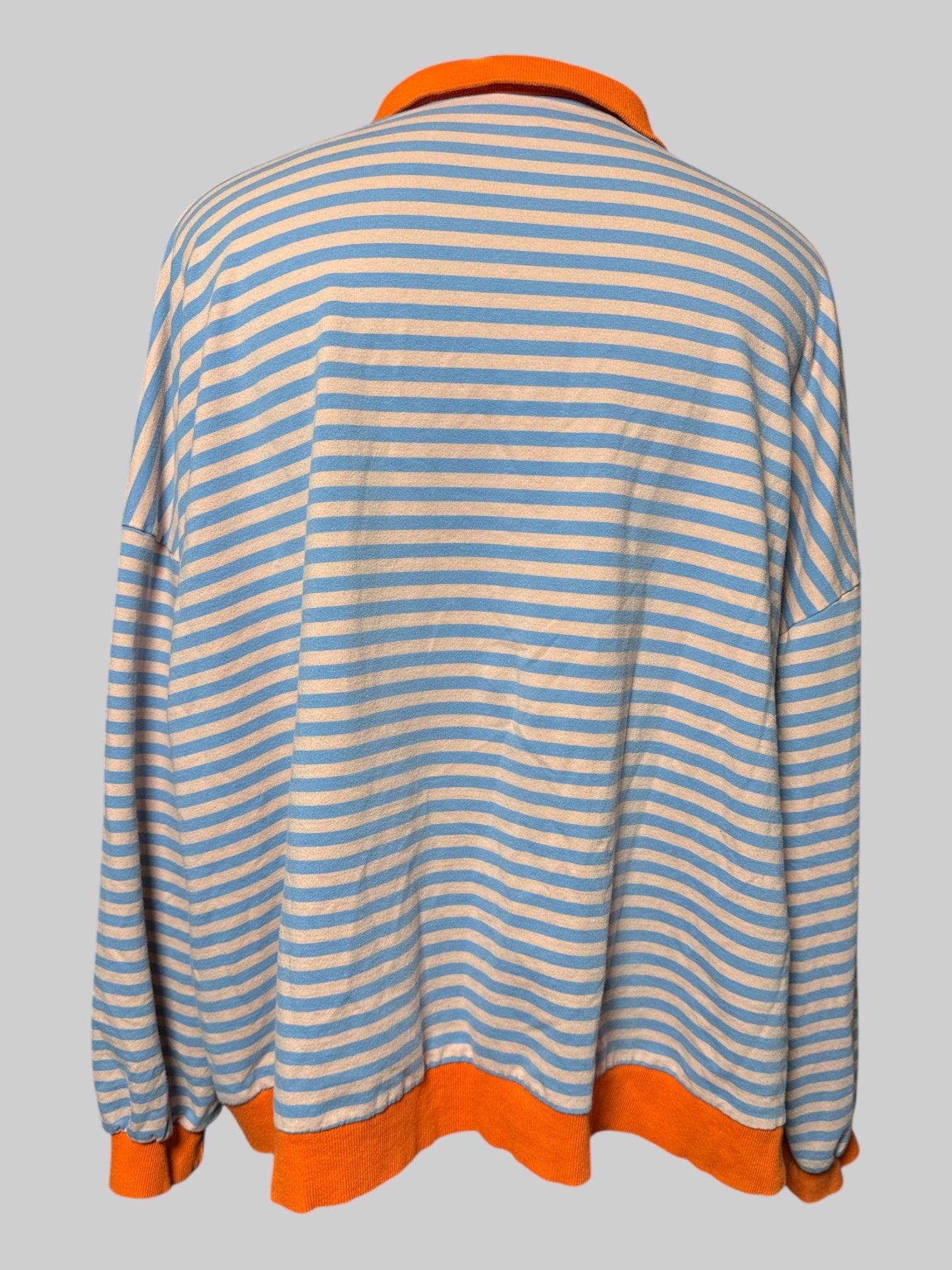 7X light, orange and blue striped long sleeve top with collar and two buttons, and orange hems and cuffs
