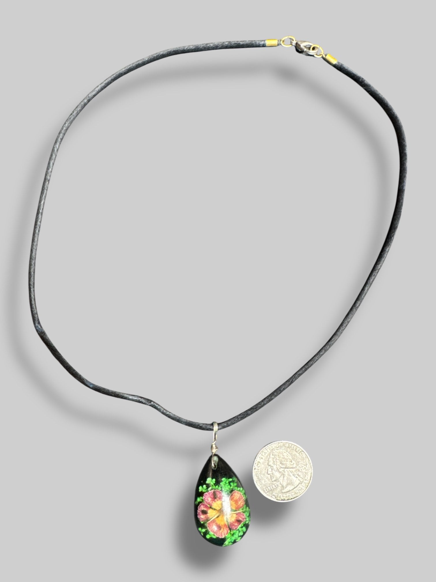 Black resin floral pendant necklace with black cord