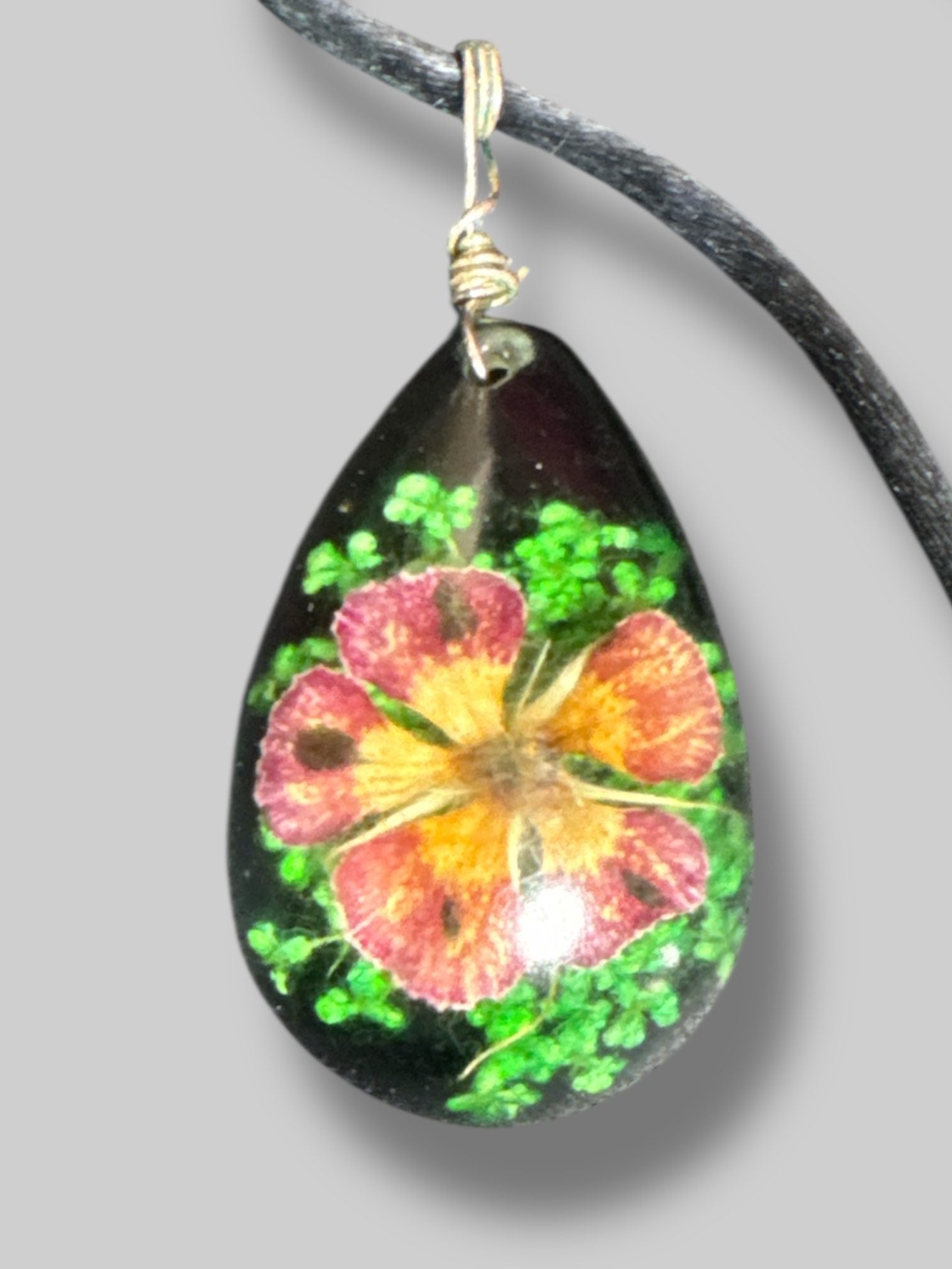 Black resin floral pendant necklace with black cord