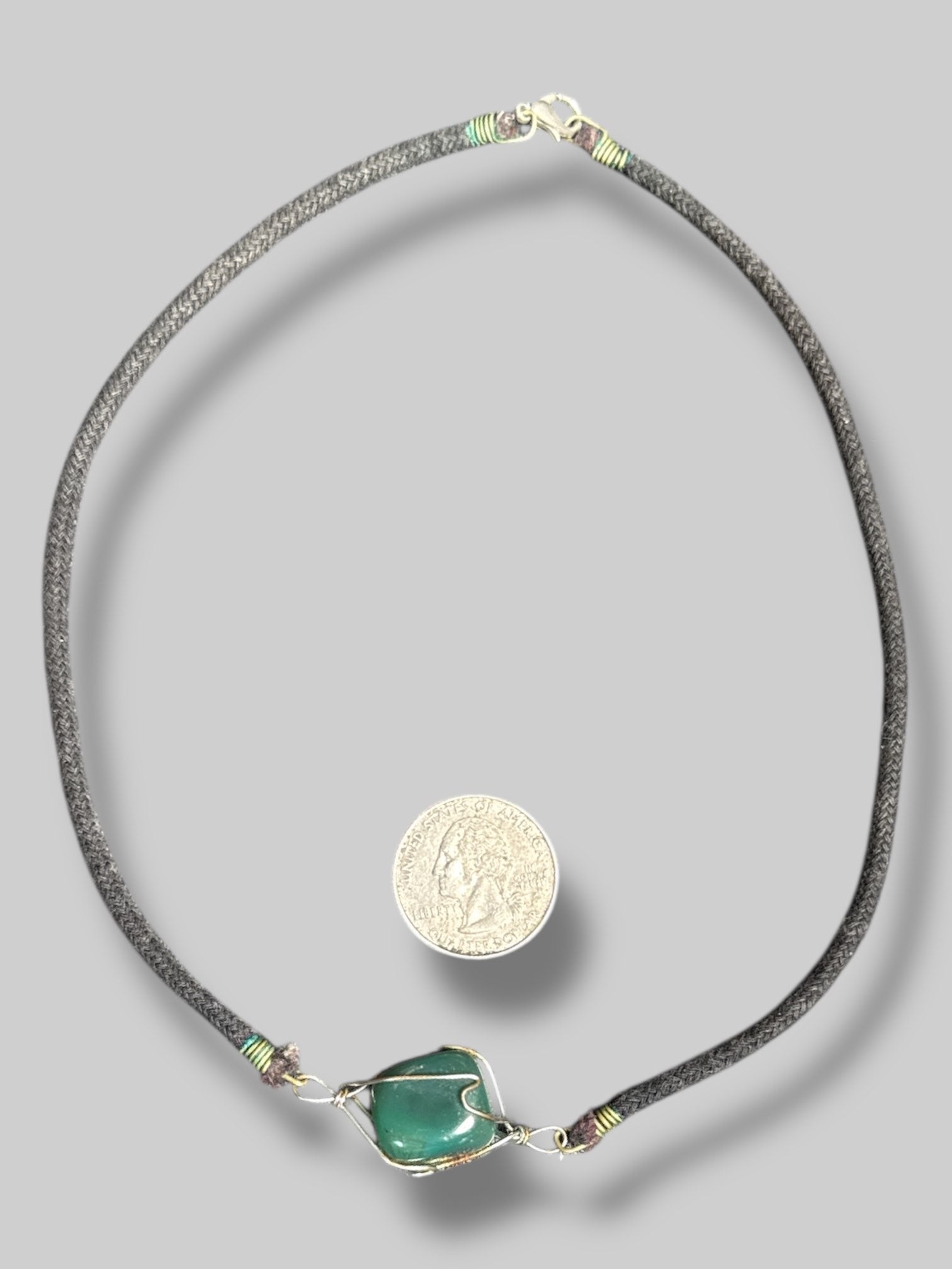 Wire wrapped crystal necklace with a black cord Light