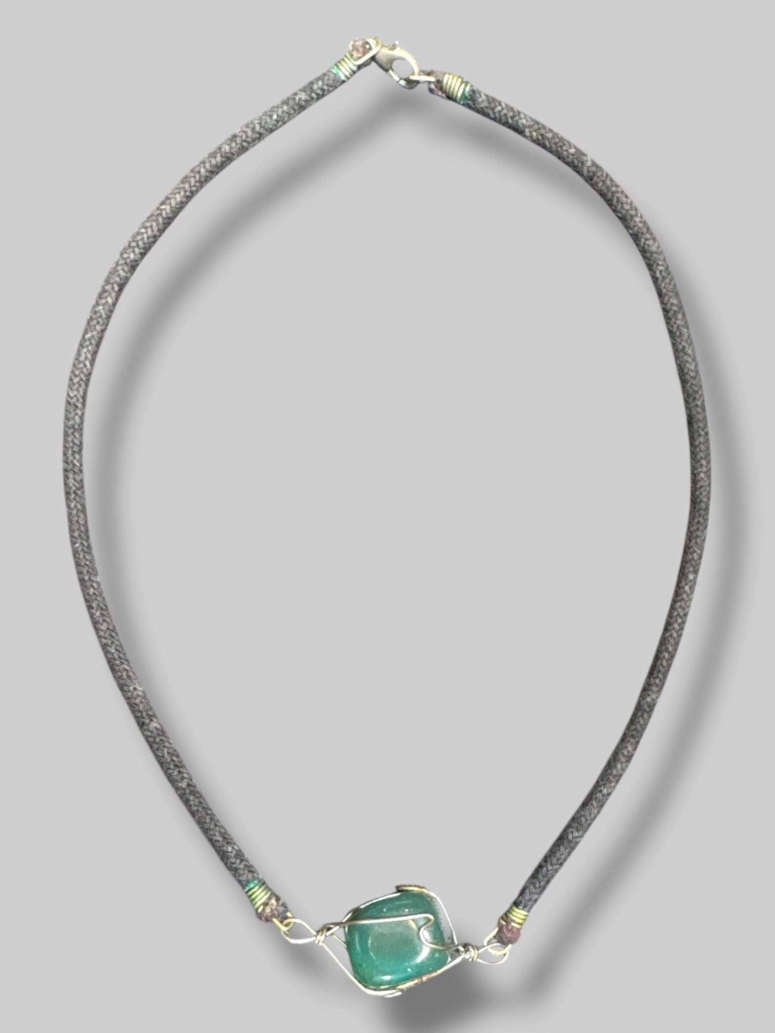 Wire wrapped crystal necklace with a black cord Light