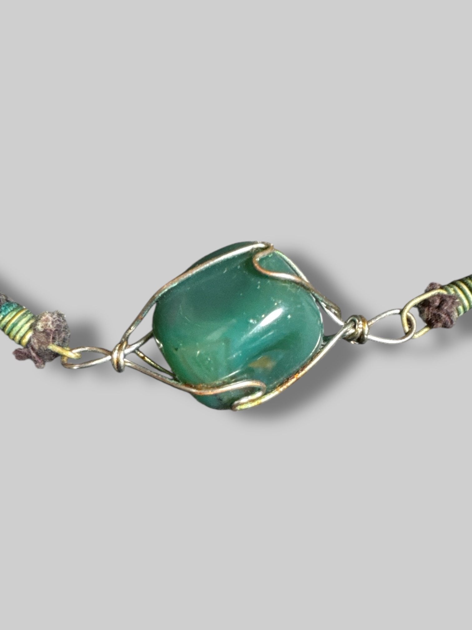 Wire wrapped crystal necklace with a black cord Light