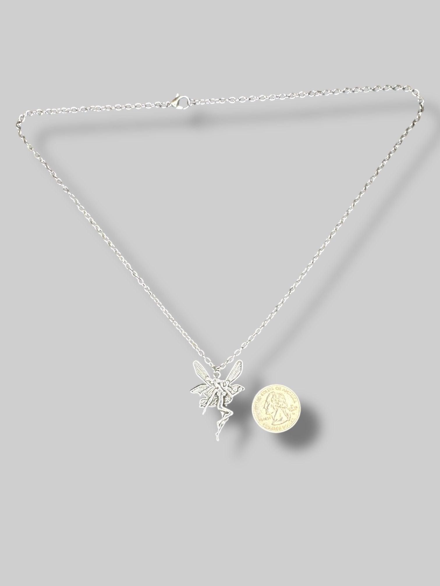 Silver tone necklace with fairy pendant