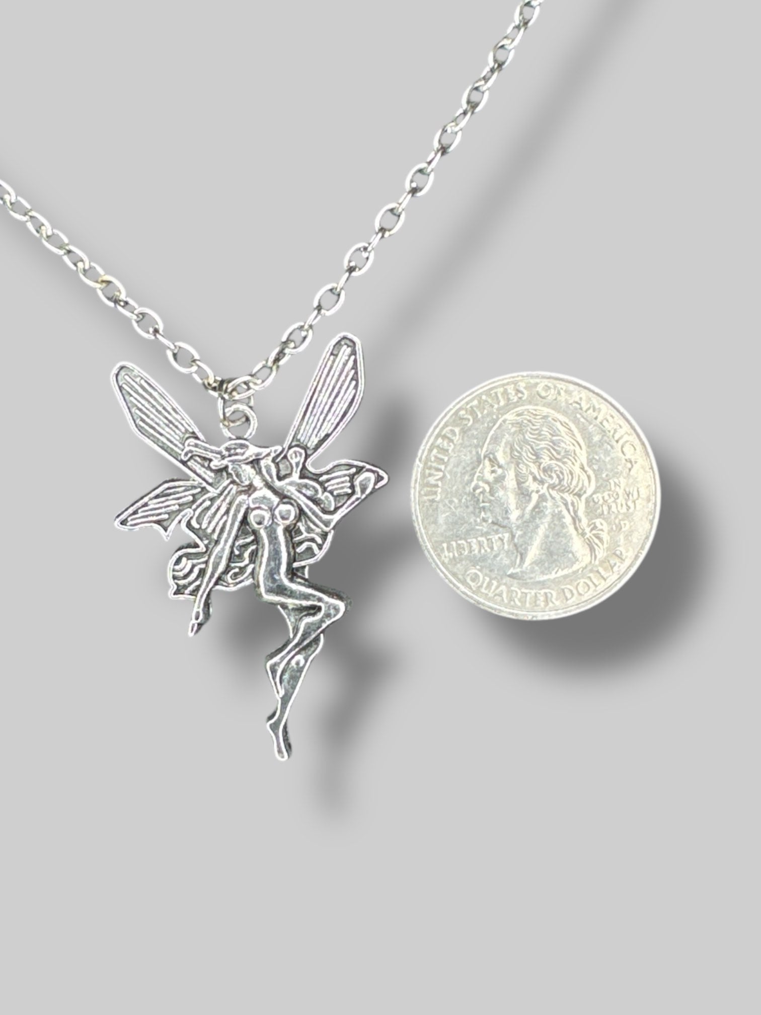 Silver tone necklace with fairy pendant