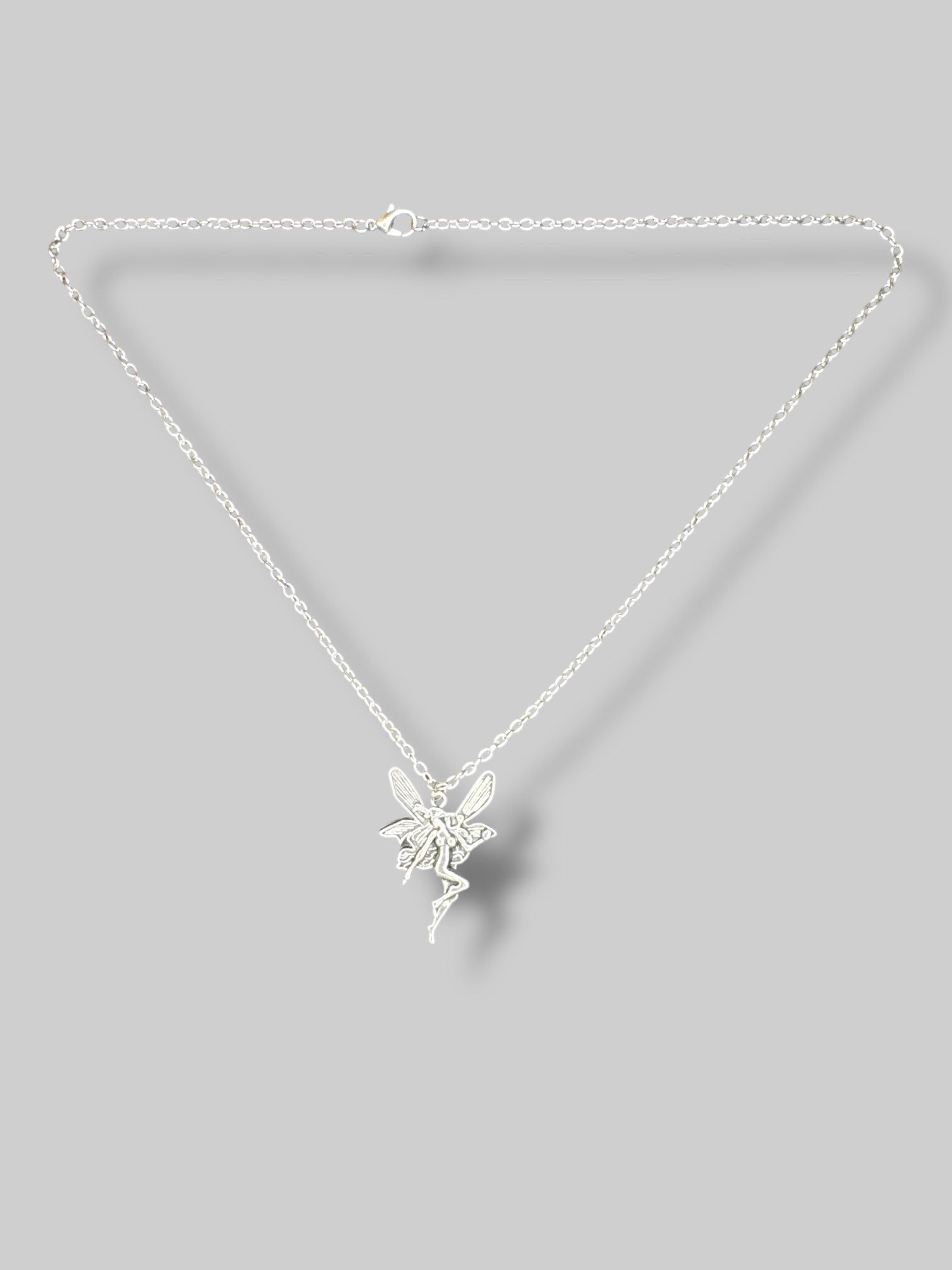 Silver tone necklace with fairy pendant